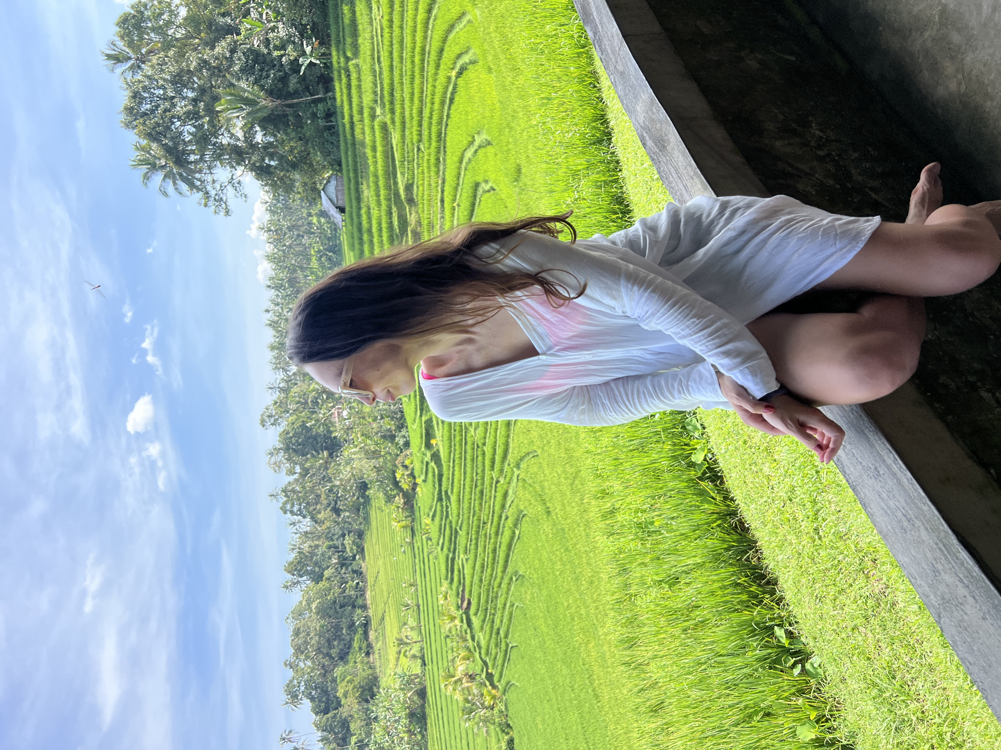 Woman photographs scenic rice terraces in Pupuan, Indonesia