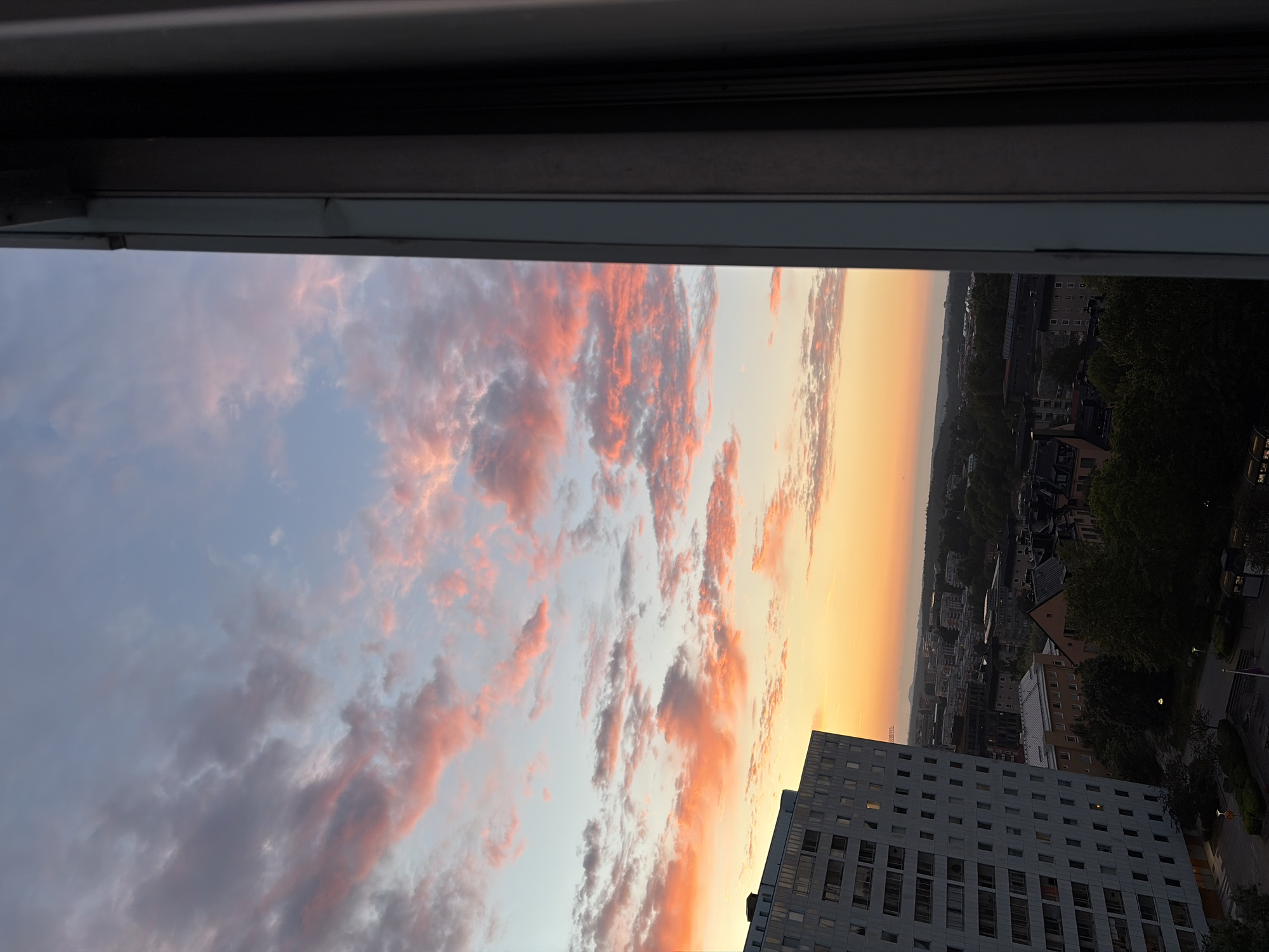 Sunset over Solna's apartment blocks, golden hour clouds.