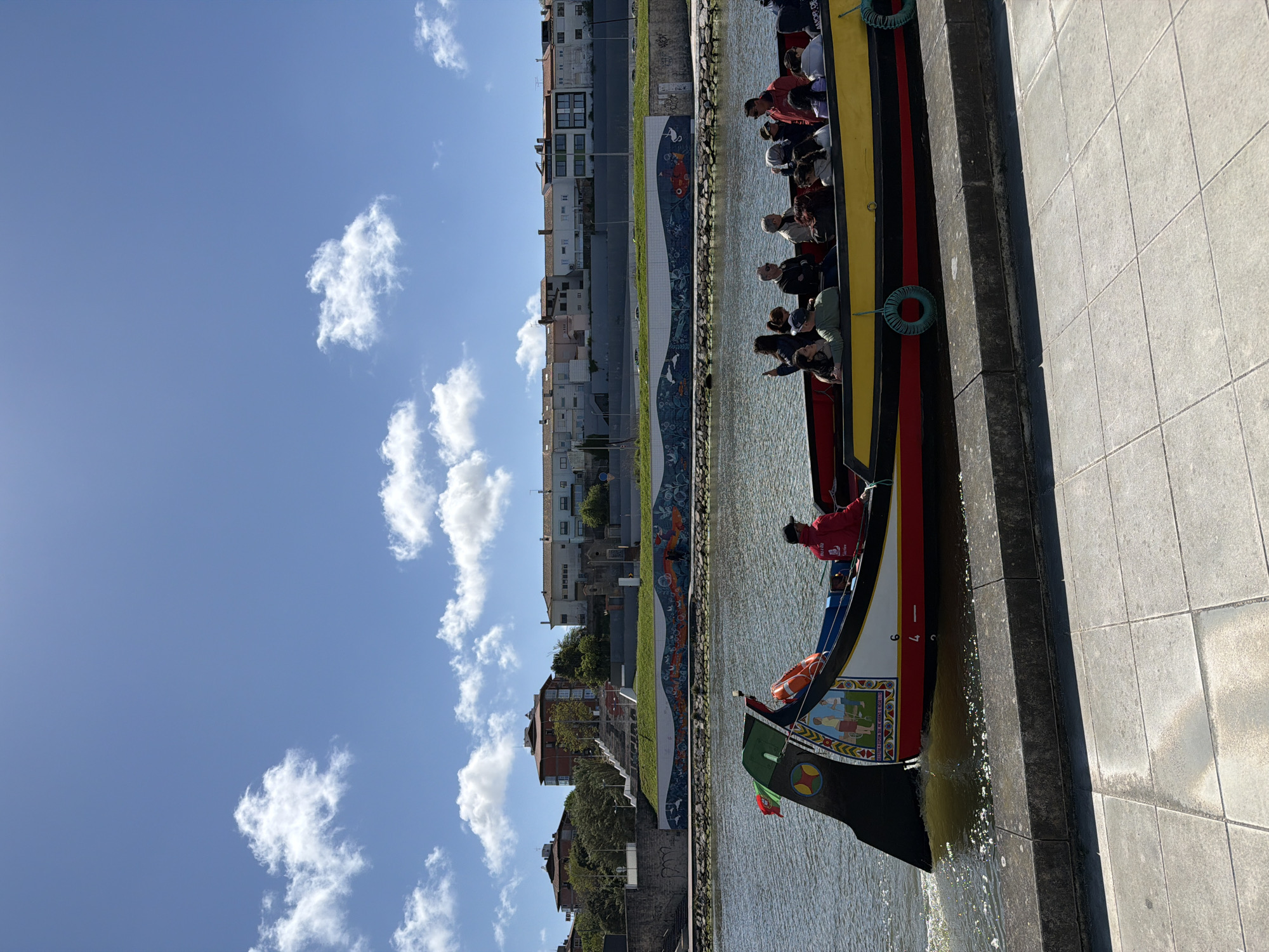 Tourists explore Aveiro's canals via traditional moliceiro boats