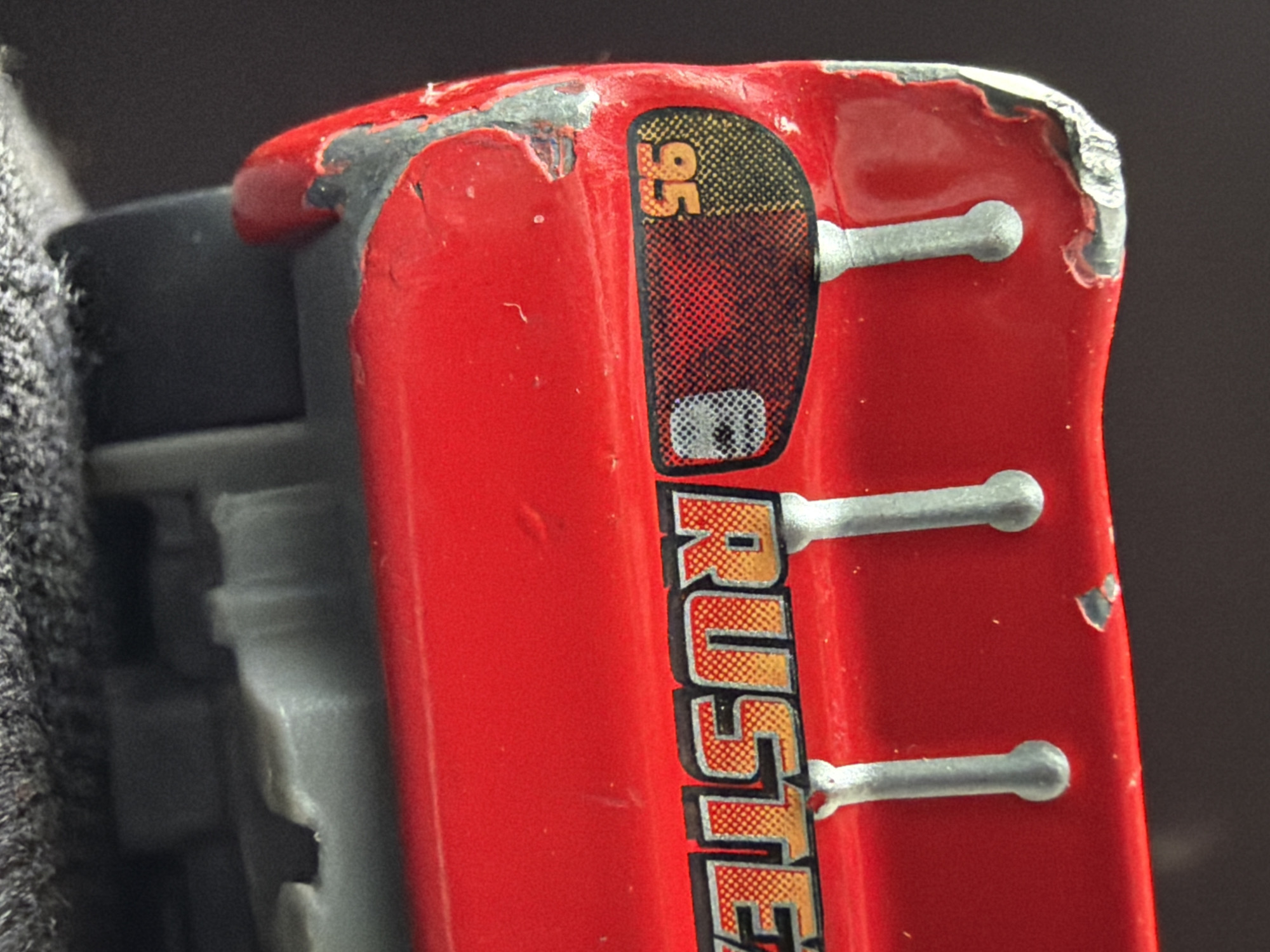 Weathered Lightning McQueen toy photographed in Russian village