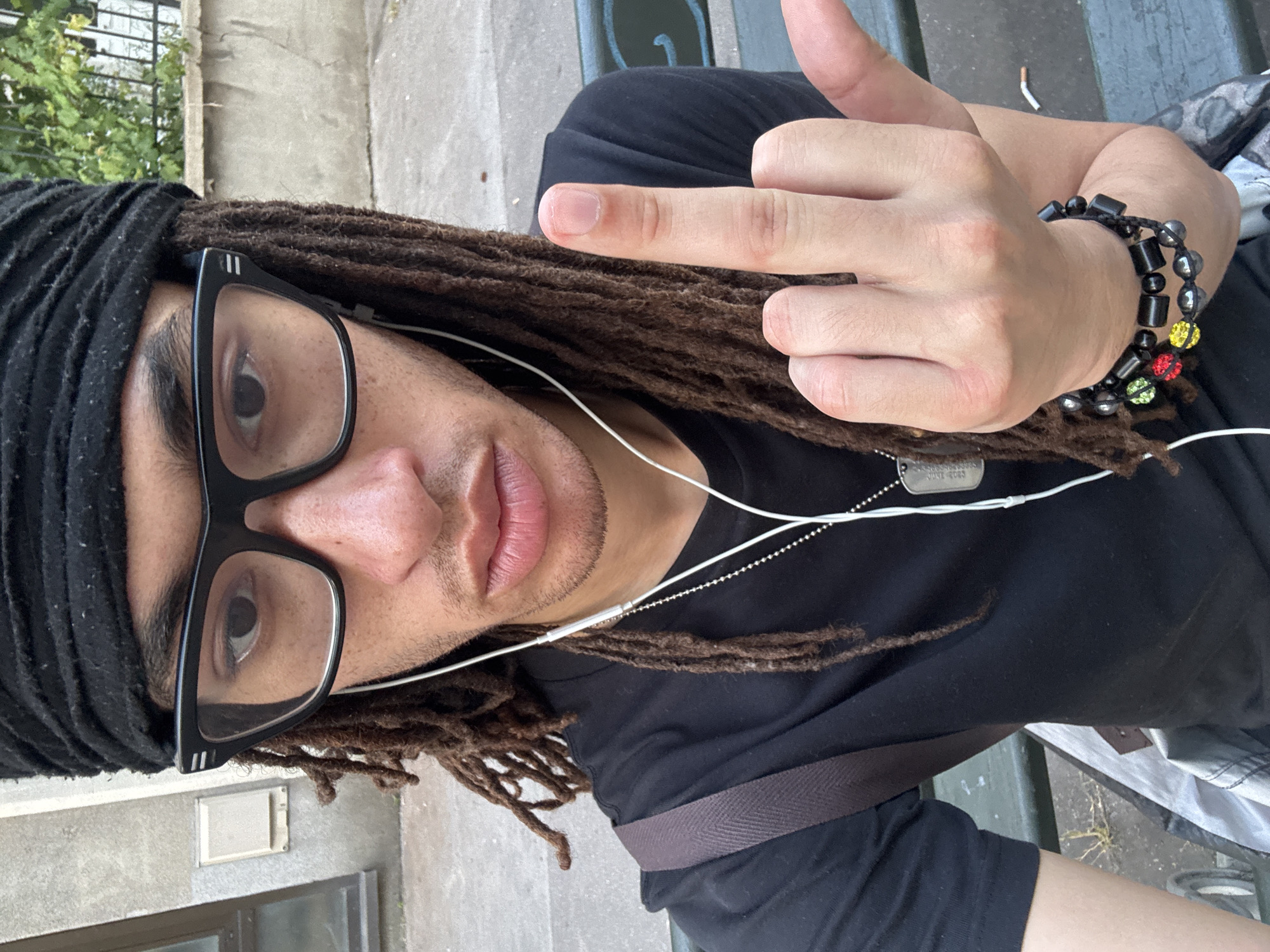 Person with dreadlocks spotted wearing headphones in Paris