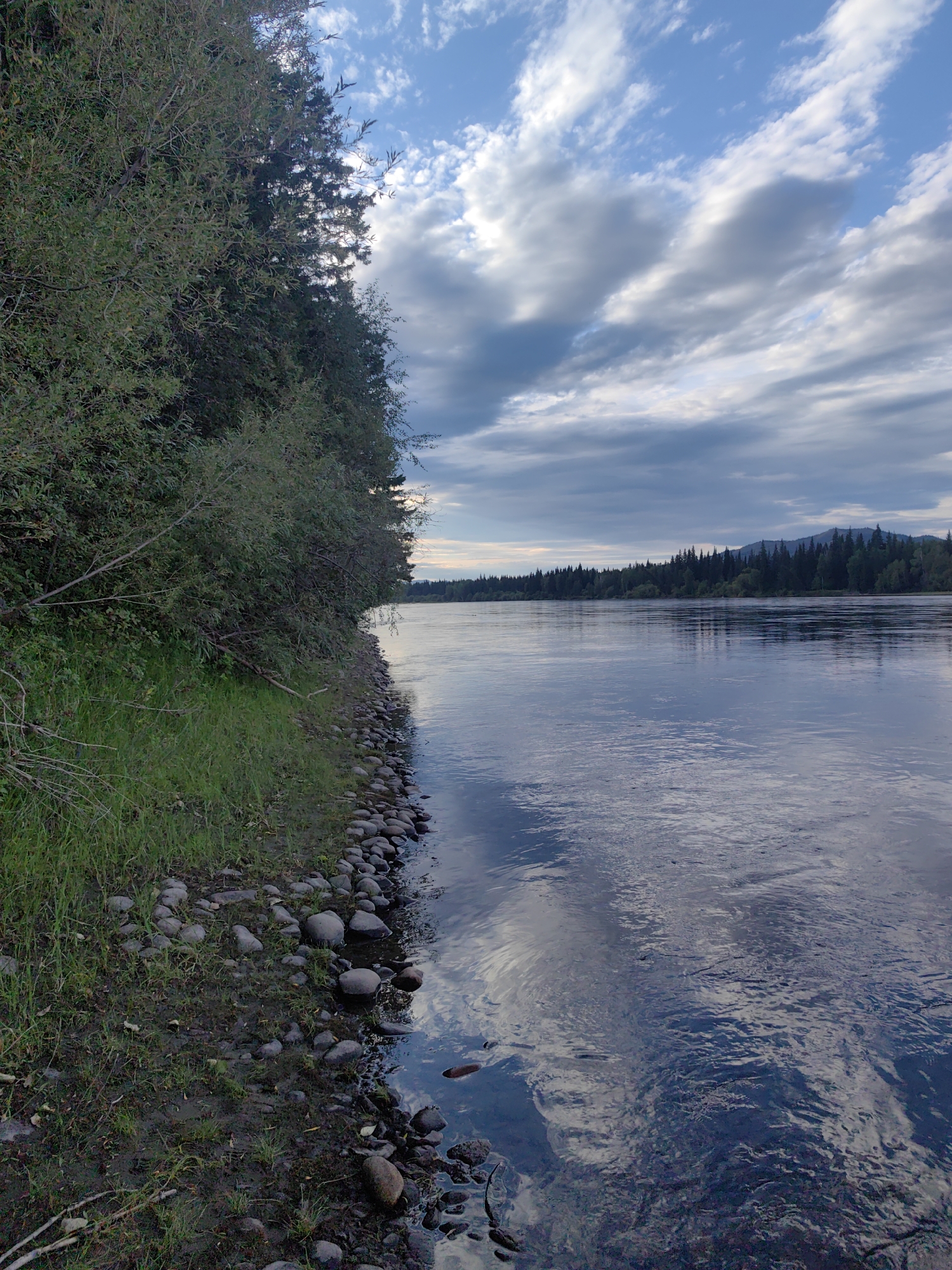A lazy summer afternoon fishing on a calm Siberian river