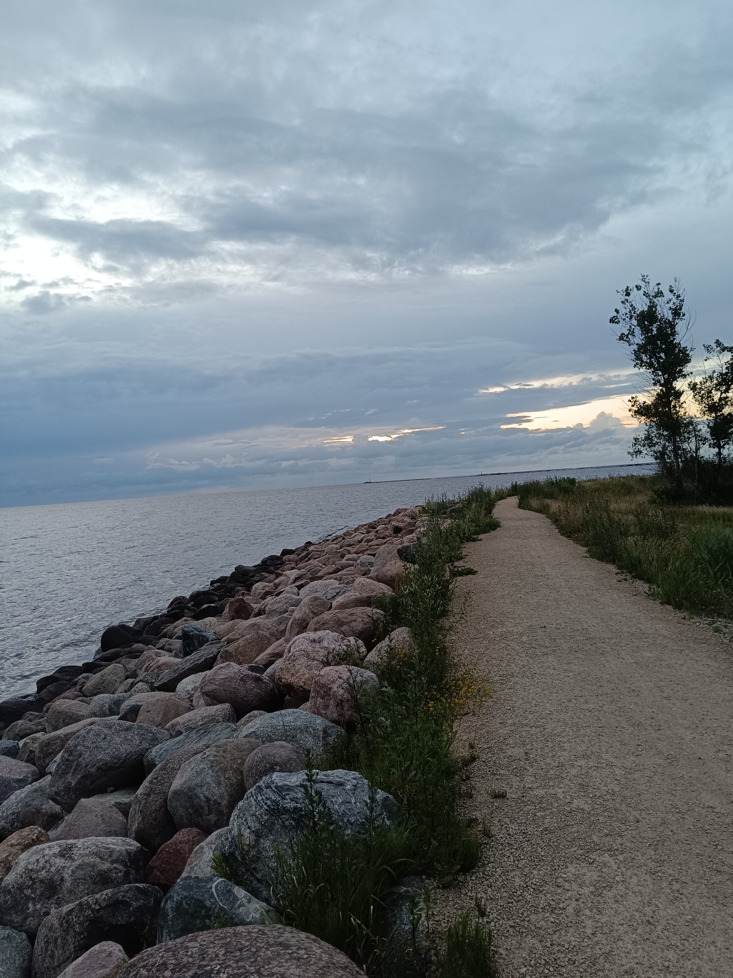 Riga's rocky coastline at dusk under a stormy sky