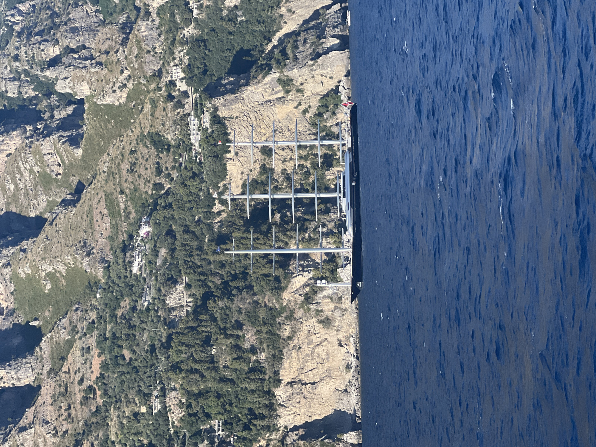 Boat journey captures Amalfi Coast views, anchored yacht