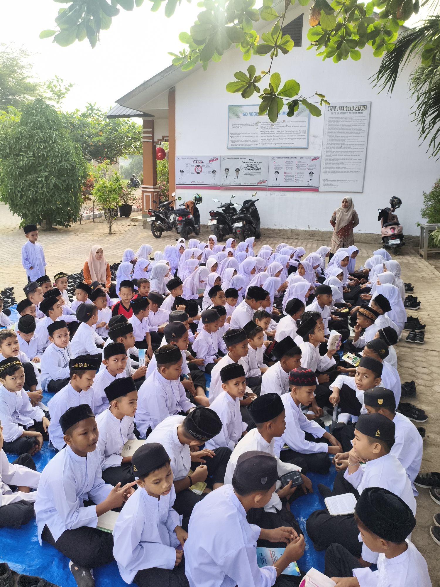 Students gather outdoors for Islamic study session in Baratpayaitek