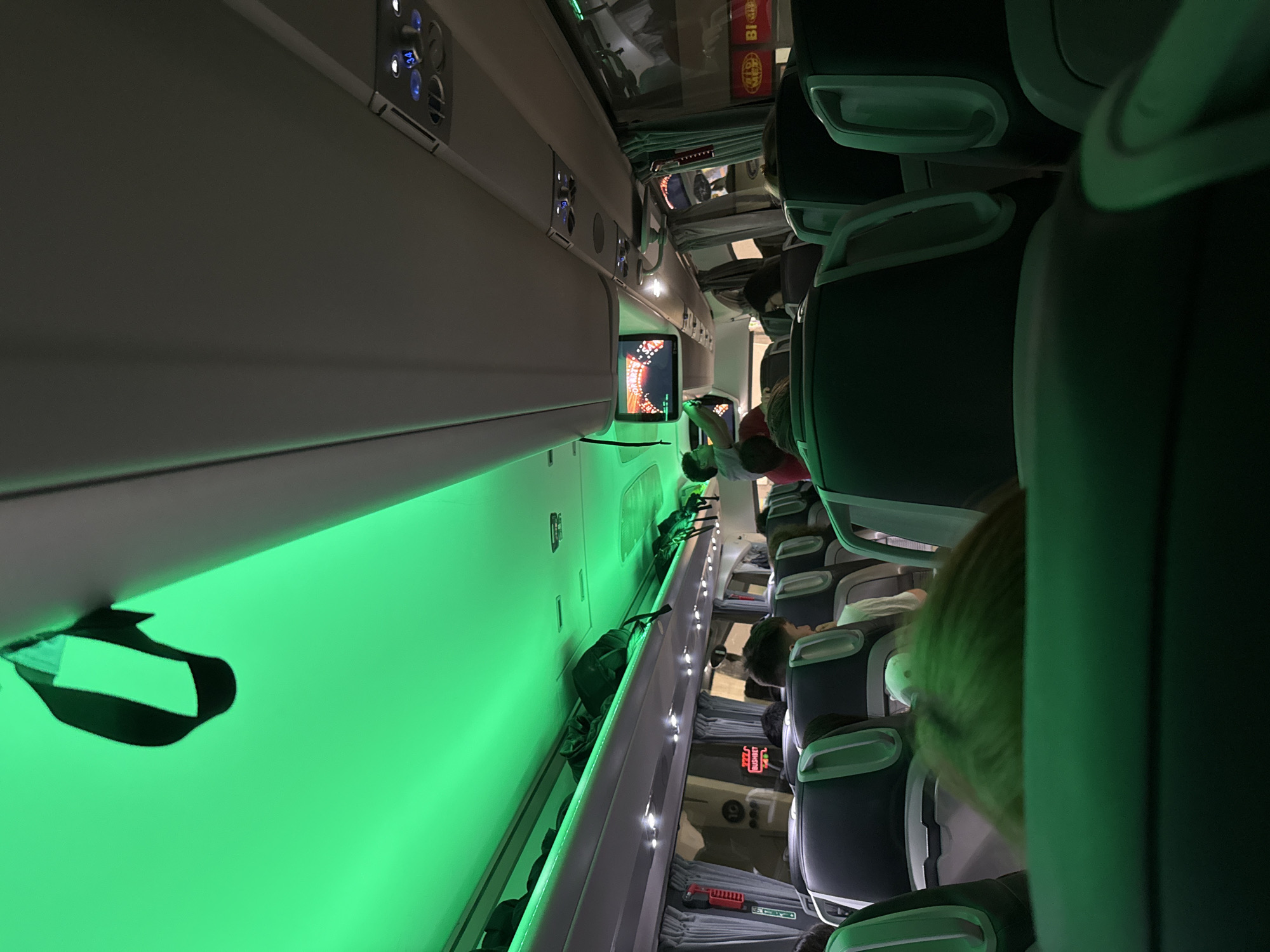 Passenger documents aircraft cabin with green lighting near Varna