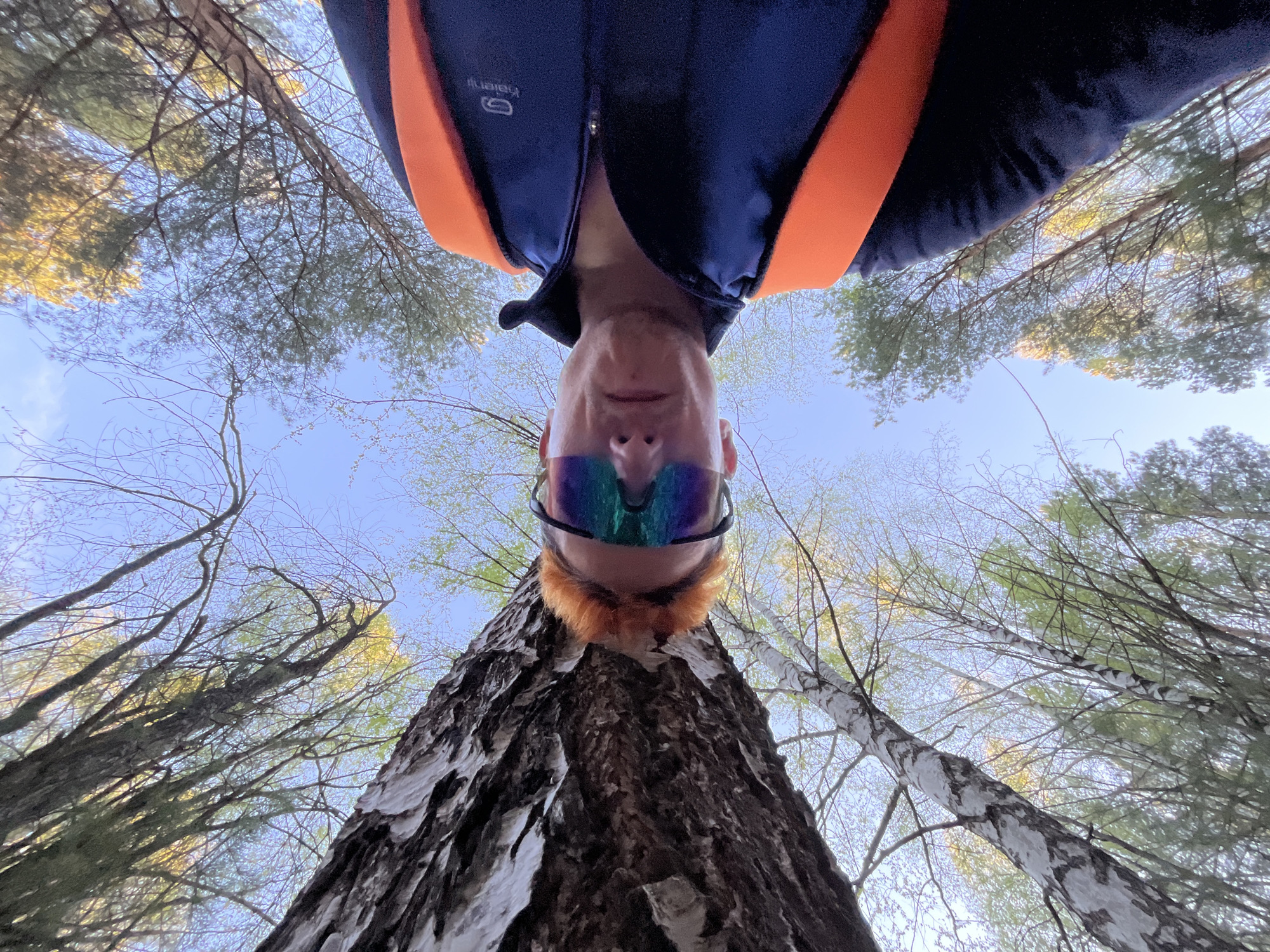 Person in blue jacket photographed in low-angle selfie in Chaikovsky