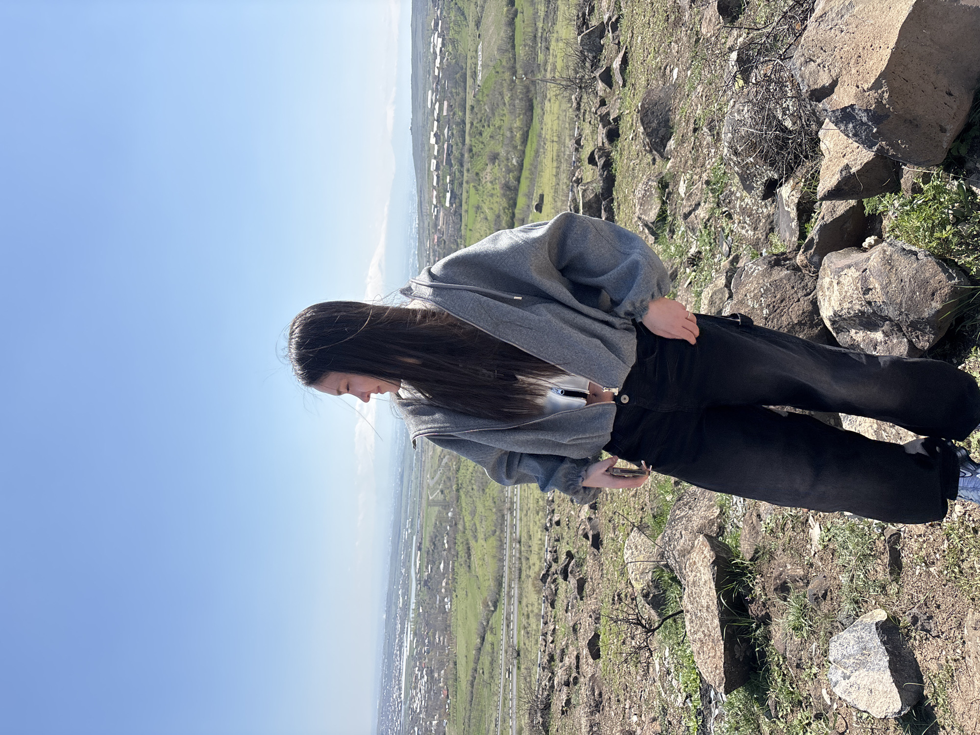 Tourists pose for photos on Byurakan hillside overlooking Armenia