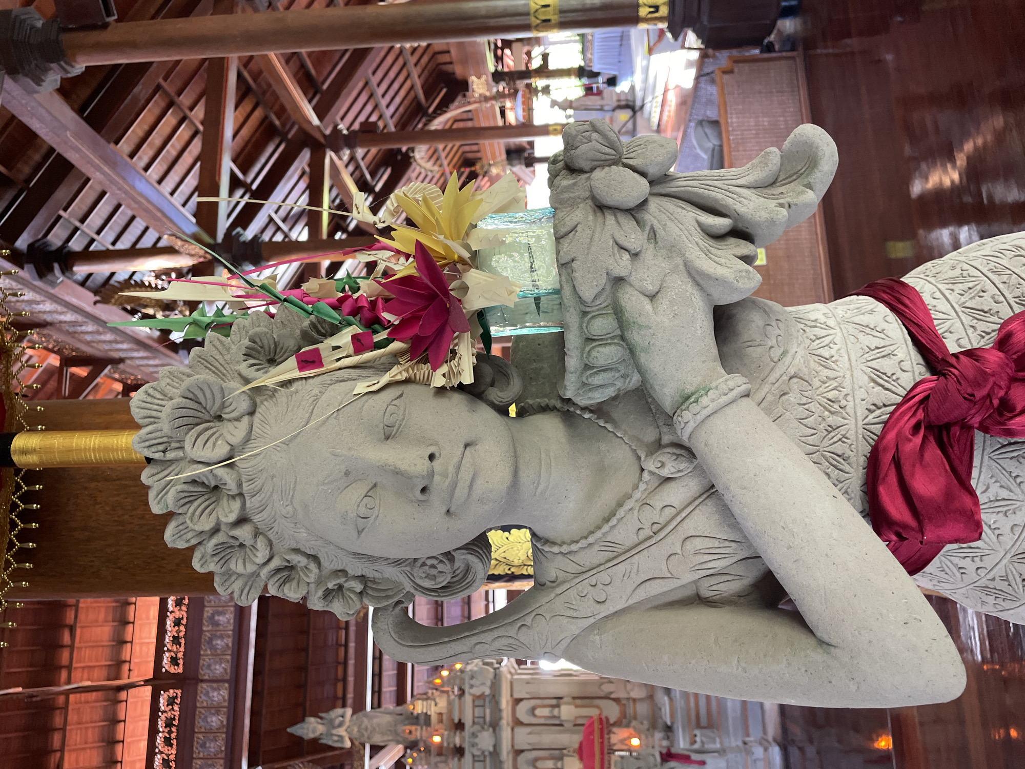 Witness documents Balinese temple complex with statues, masks, koi