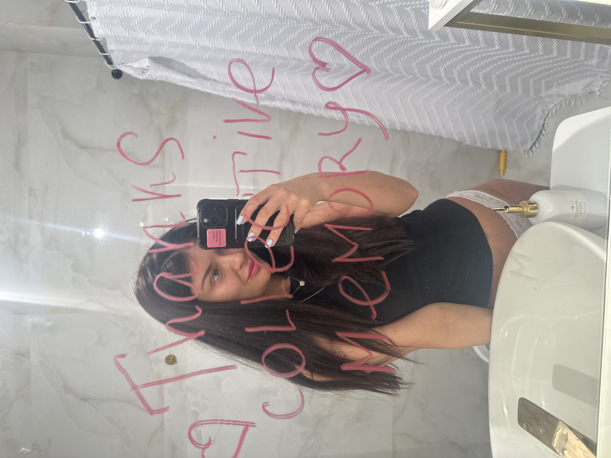 Woman takes bathroom mirror selfie in Khimki, Russia
