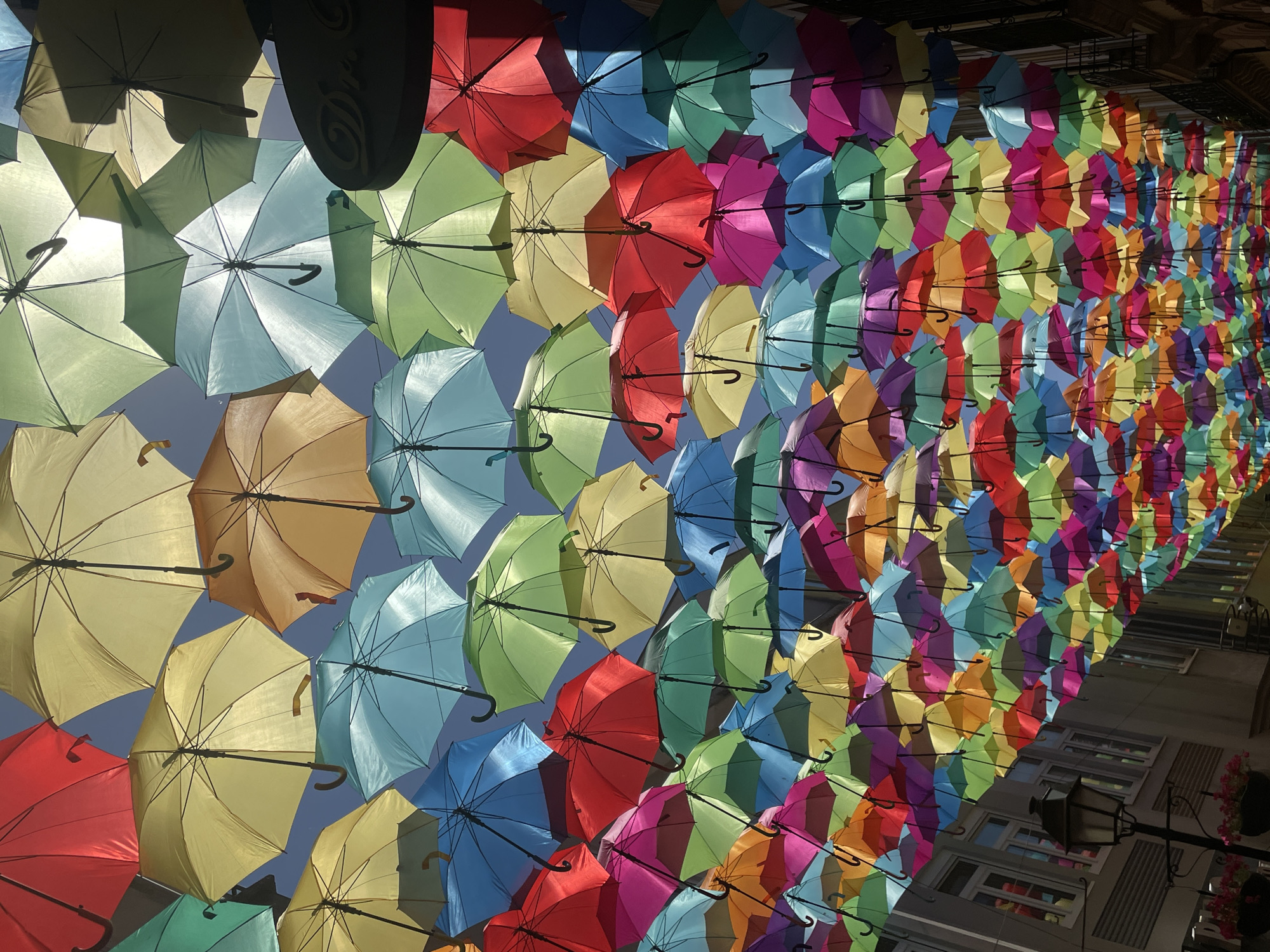 Águeda's colorful umbrella canopy and tiled streets in summer