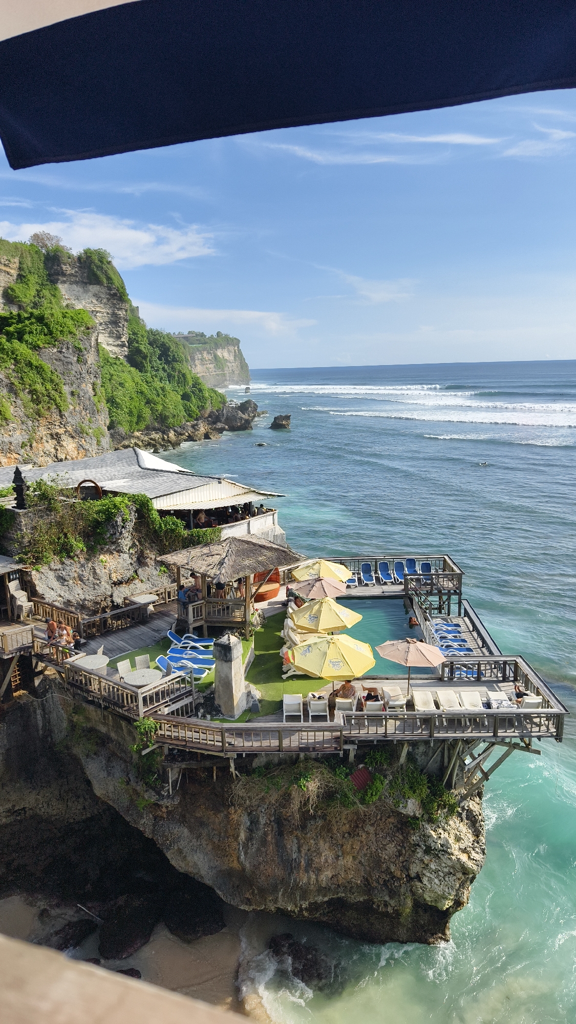 Cliffside resort with pool captured in Pecatu, Indonesia morning