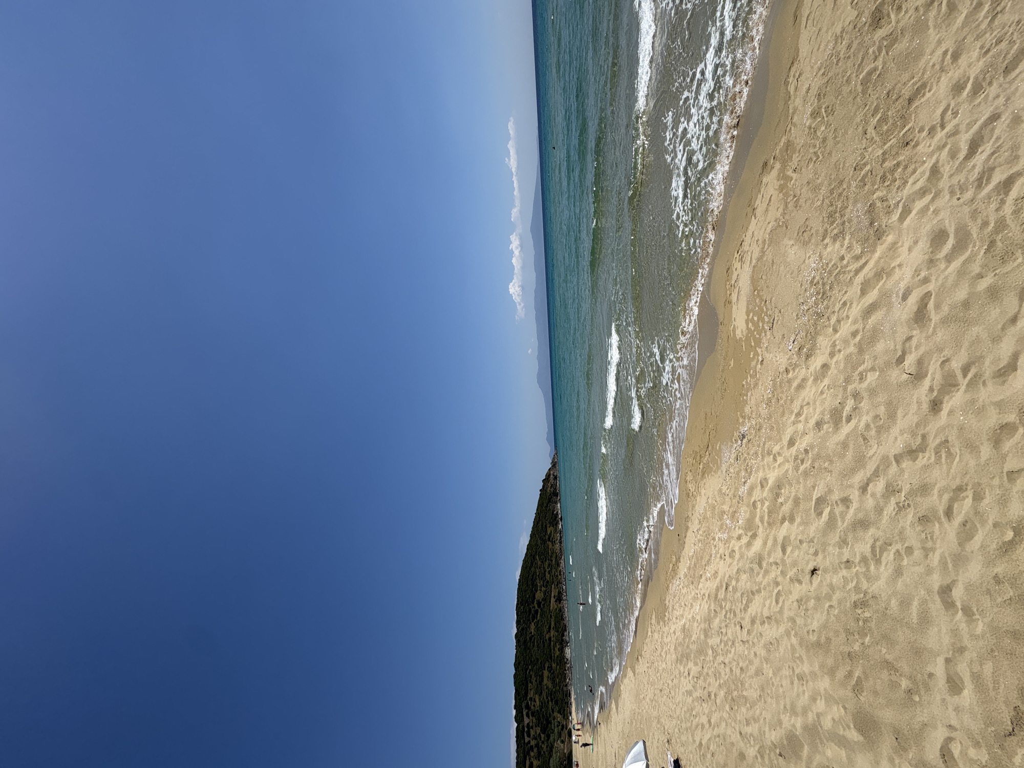 Beachgoer enjoys morning at Nea Peramos, Greece seaside