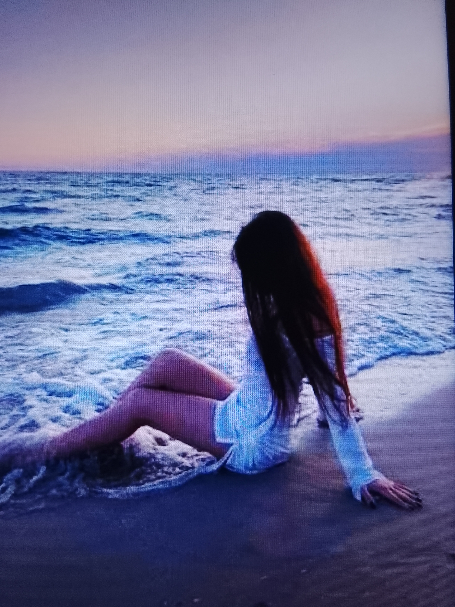 Alone at the water's edge, watching the sun go down