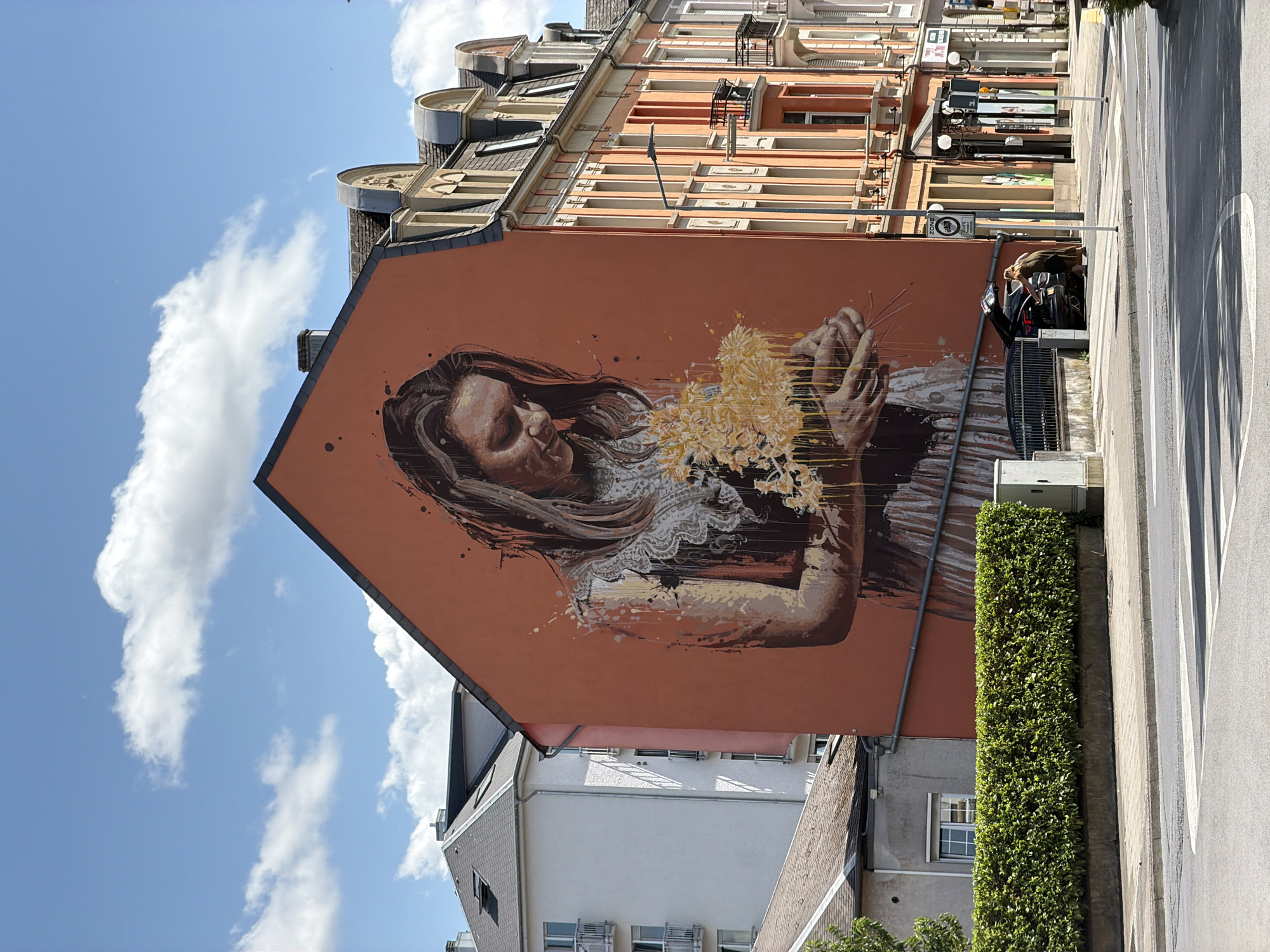 Bold mural on orange building in Esch-sur-Alzette, Luxembourg