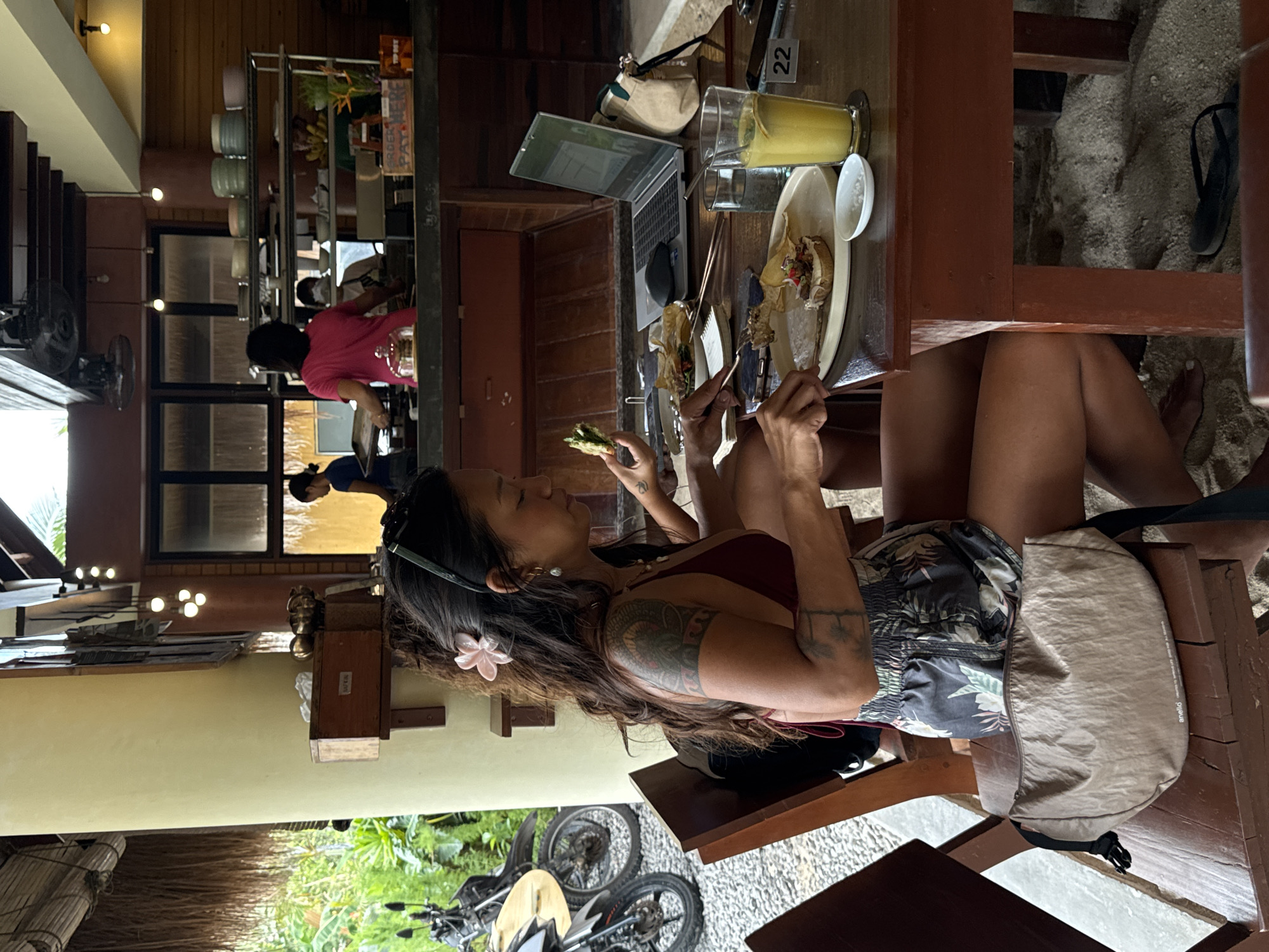 Woman dines with sleeping cat at General Luna restaurant