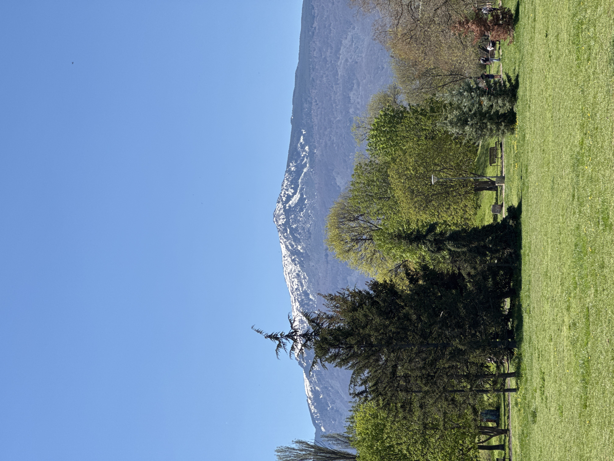 Mountain landscape with snow-capped peaks documented under clear skies