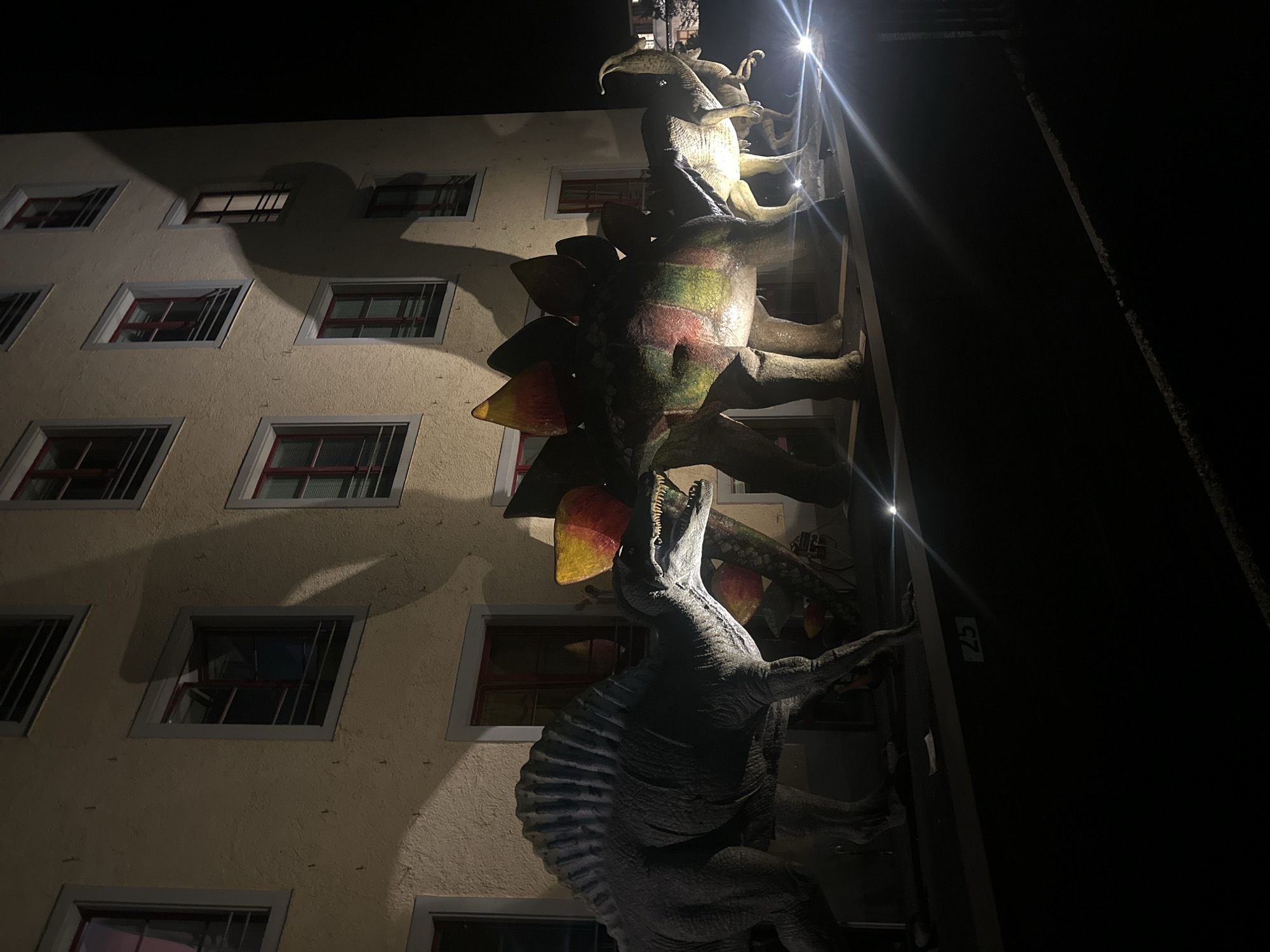Illuminated dinosaur sculptures spotted on building in Sack, Switzerland