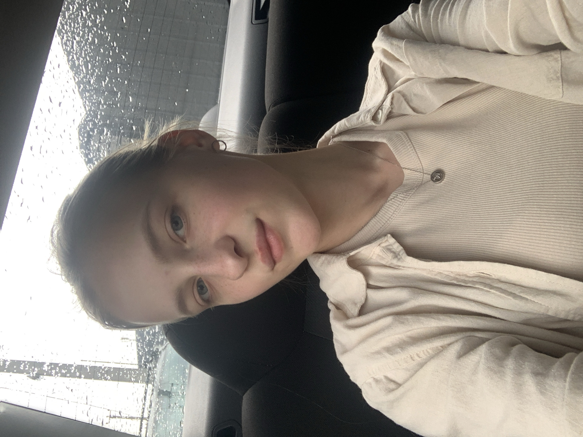 Woman photographed in vehicle during rainy day in Novi Petrivtsi