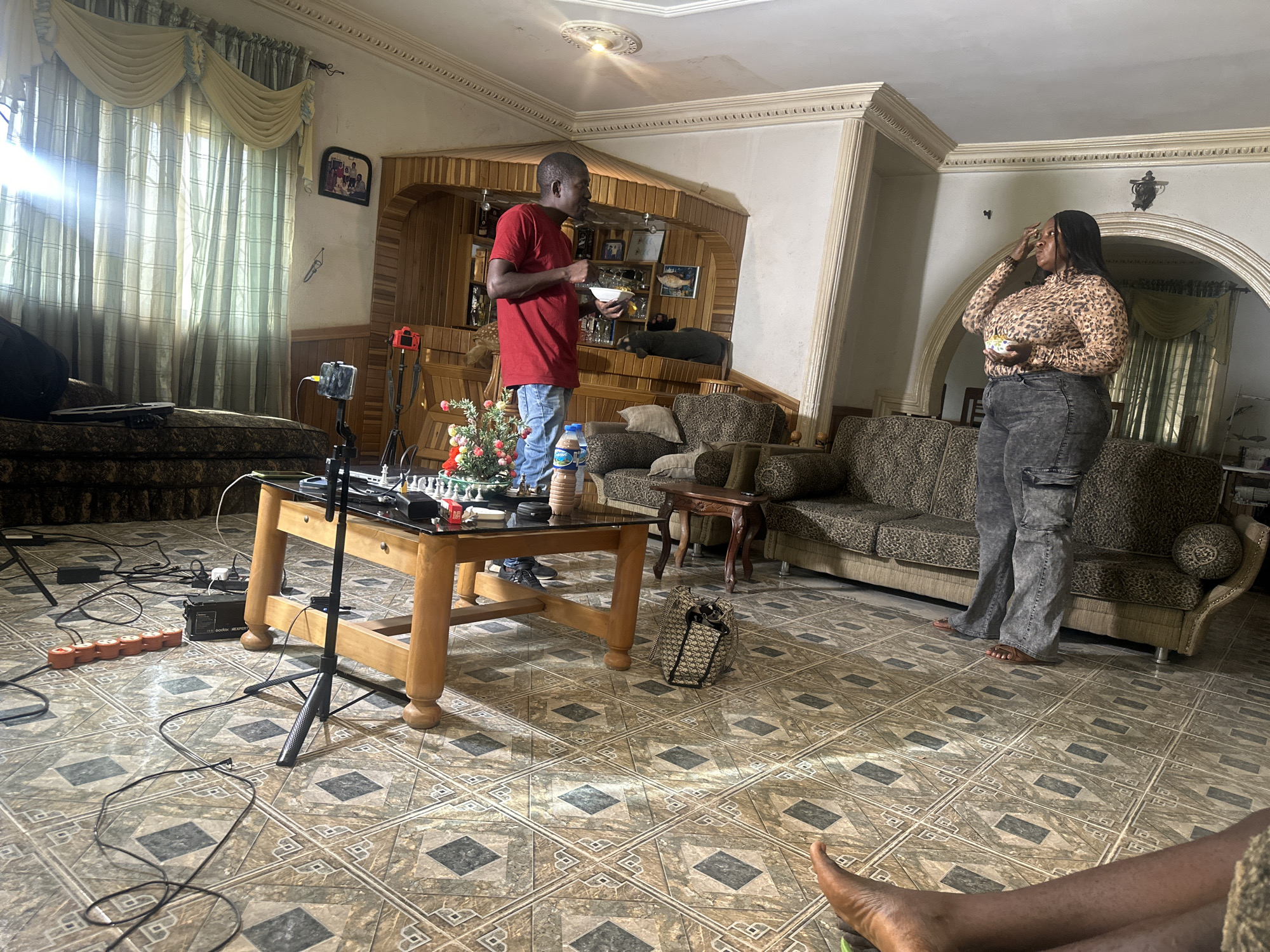 Casual indoor gathering captured during apparent filming in Jos