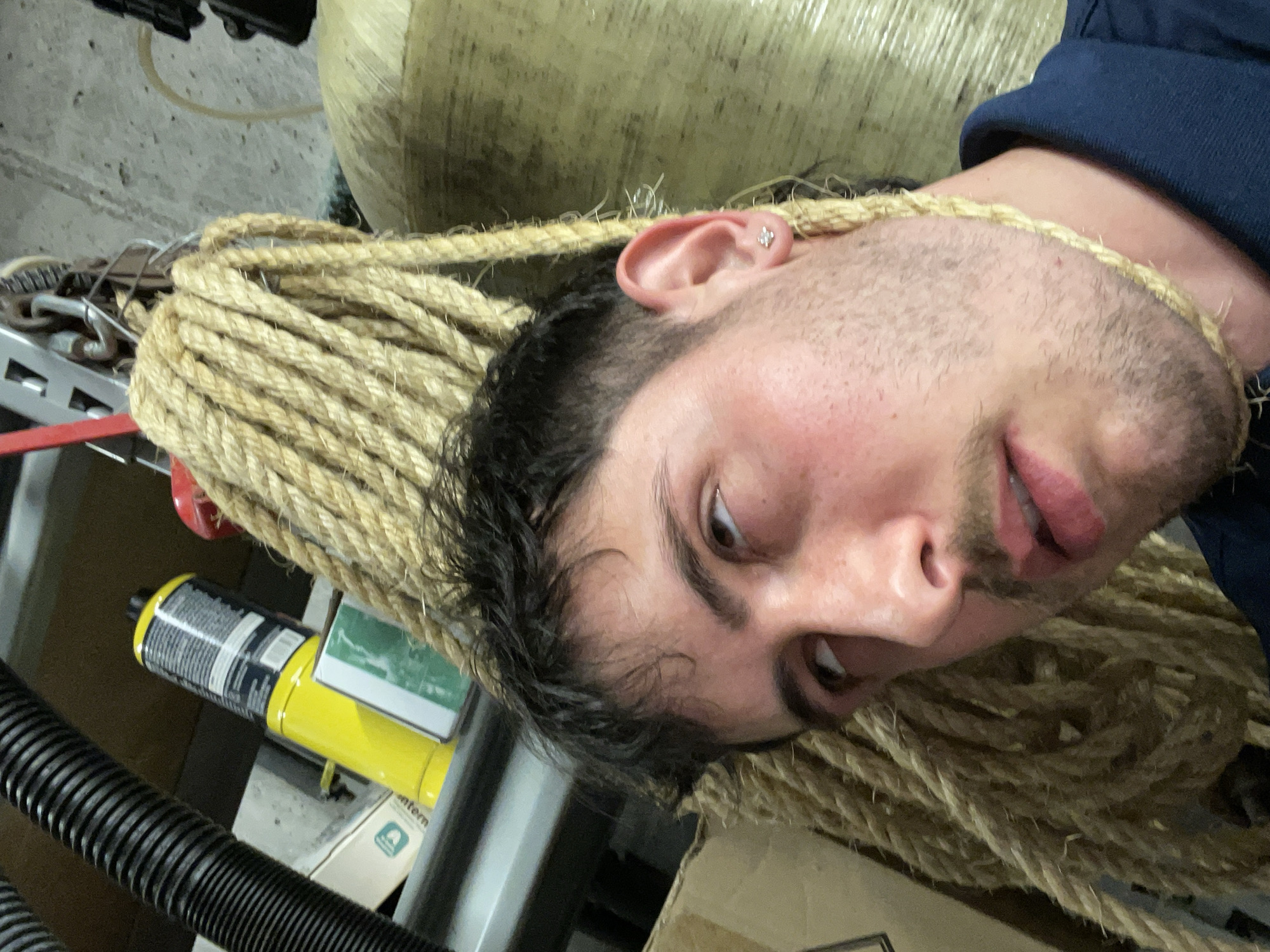 Man resting on rope in Petoskey garage storage area