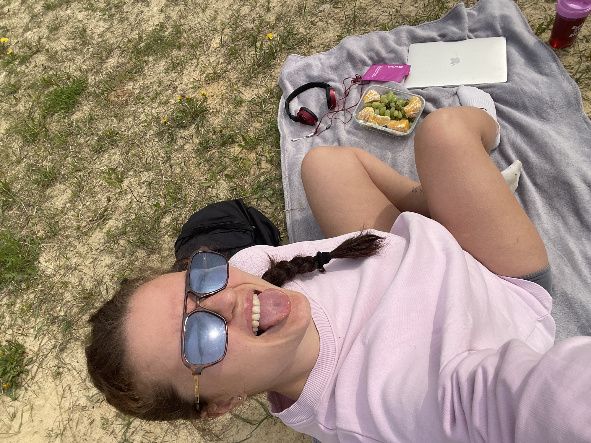 Woman enjoys lakeside picnic with technology in rural Russia