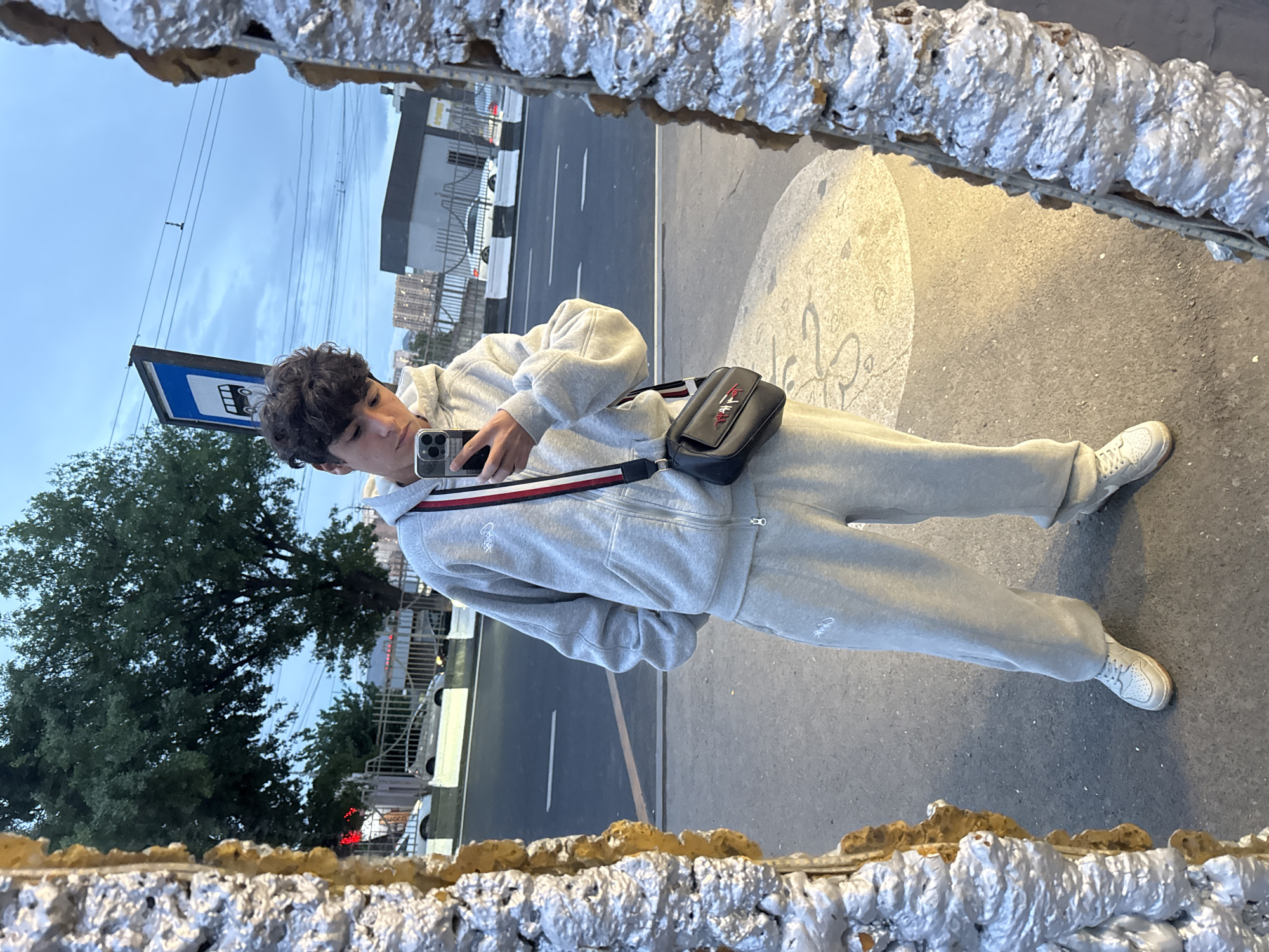 Young man takes mirror selfie at Yerevan bus stop
