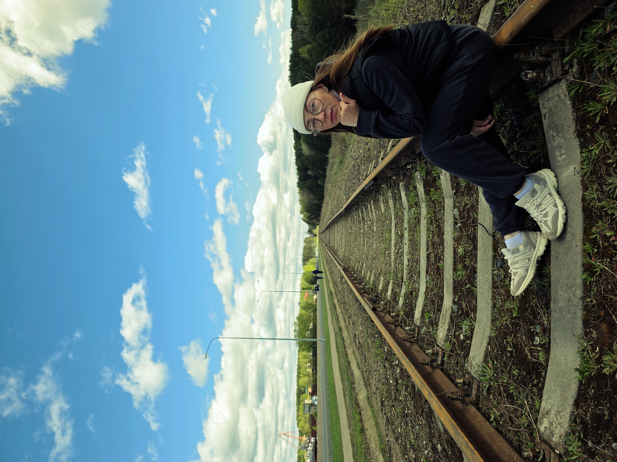 Woman poses on railway tracks in Chaikovsky, Russia