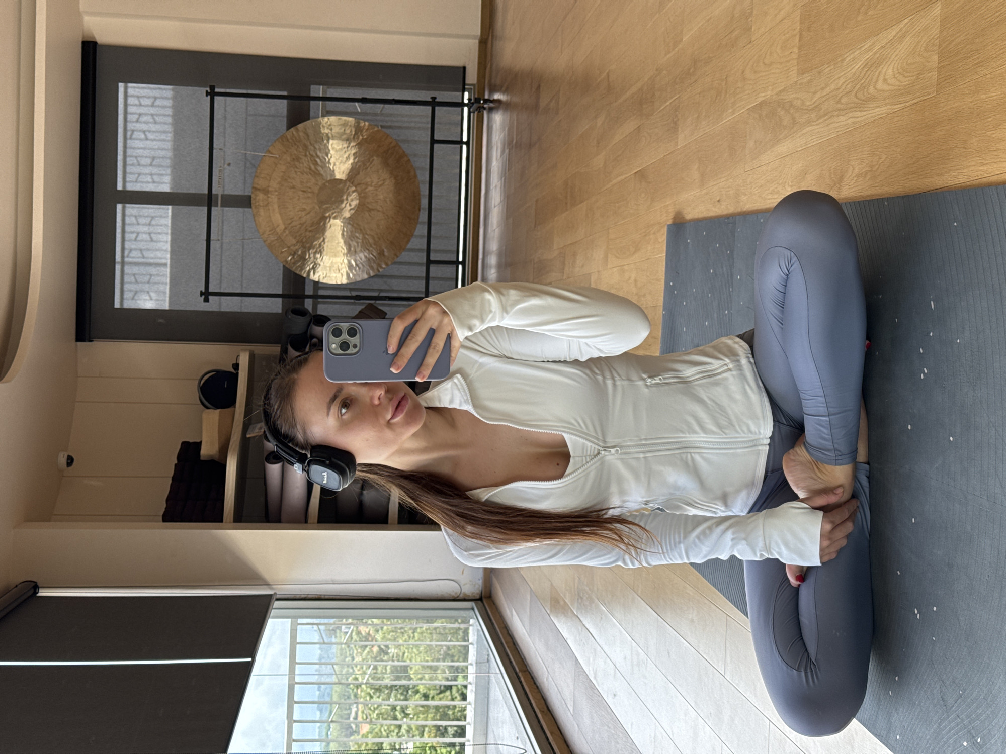 Woman practices yoga with headphones in Thai resort town
