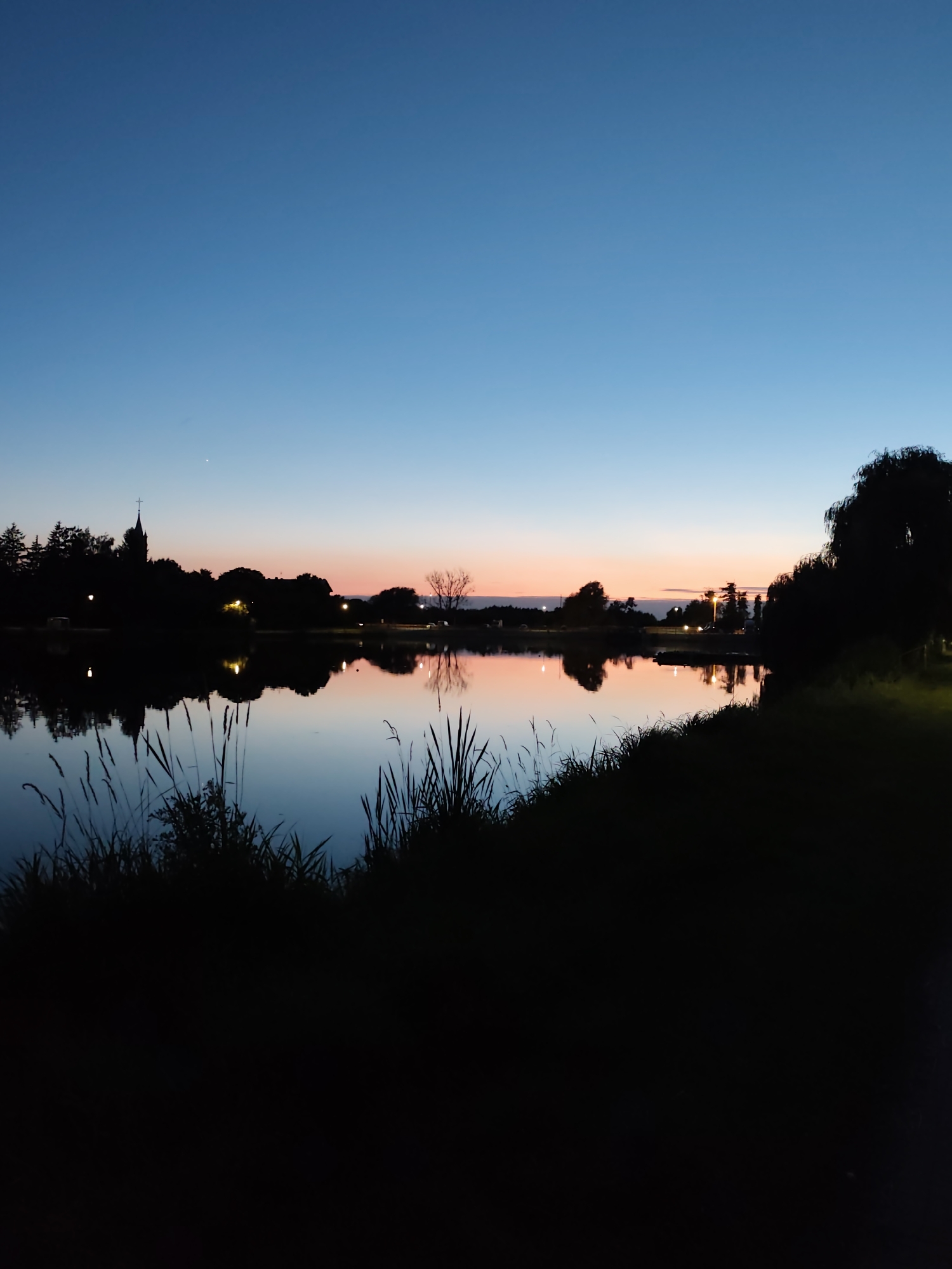 Lakefront twilight reflections in an urban park setting