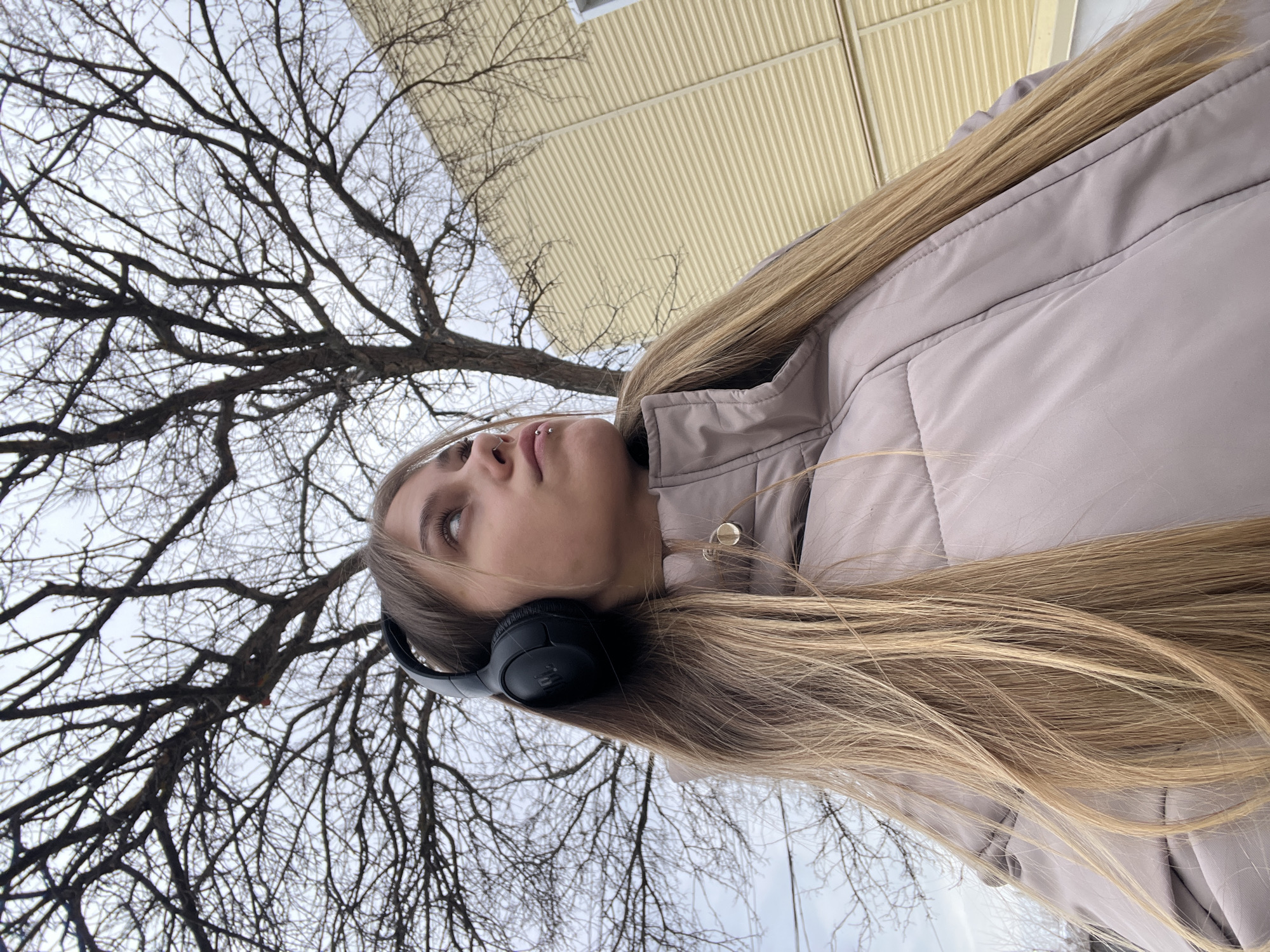Woman photographed outdoors and indoors taking selfie in Фоки