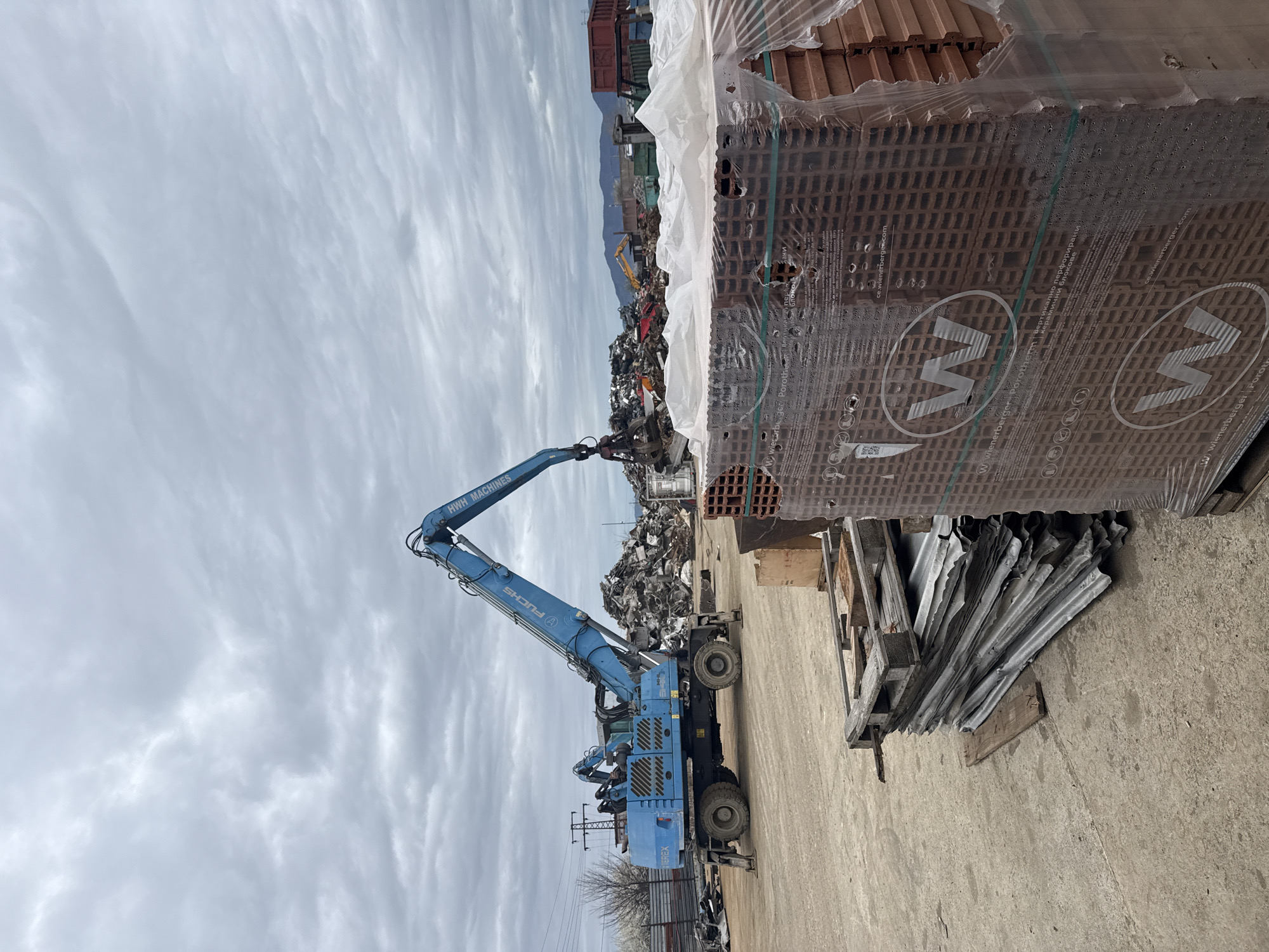 Industrial crane operates in Bulgarian scrapyard facility