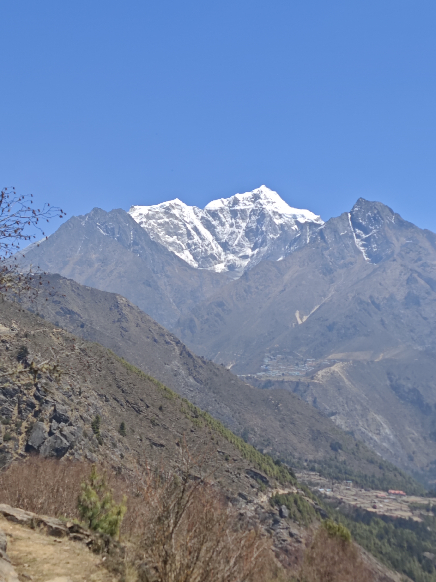 Hiker documents mountain views in Khumjung valley, Nepal