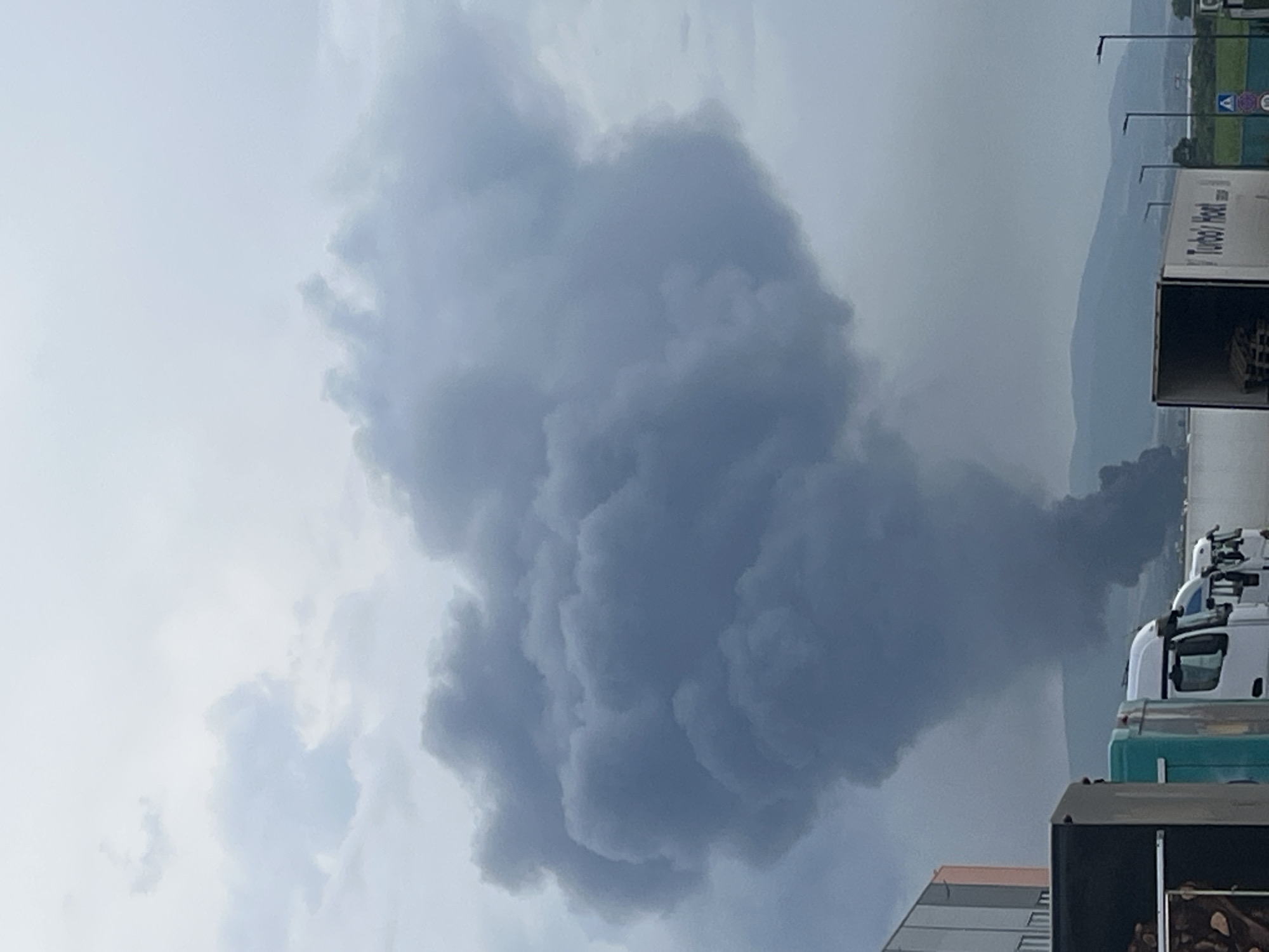 Heavy smoke plume rises over mountains from unknown fire source