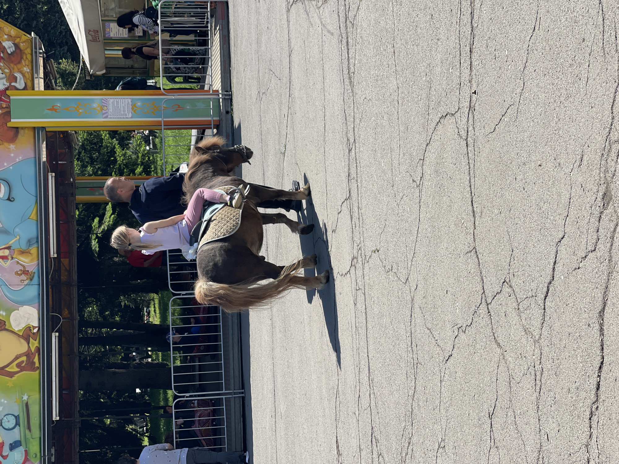 Family enjoys morning amusement park visit with poodle in Sofia
