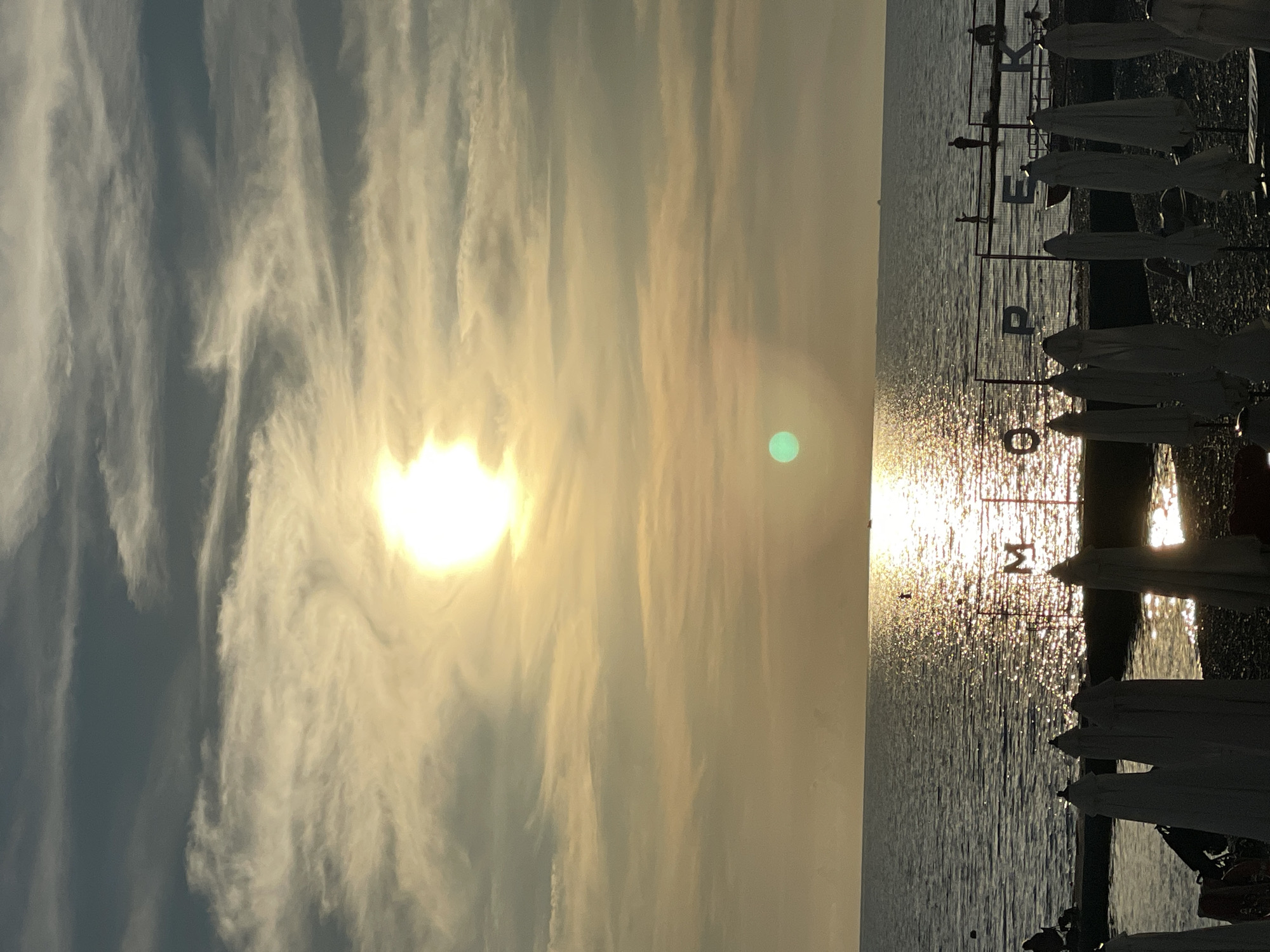 Sunset evening at Sochi beach with promenade and seaside dining