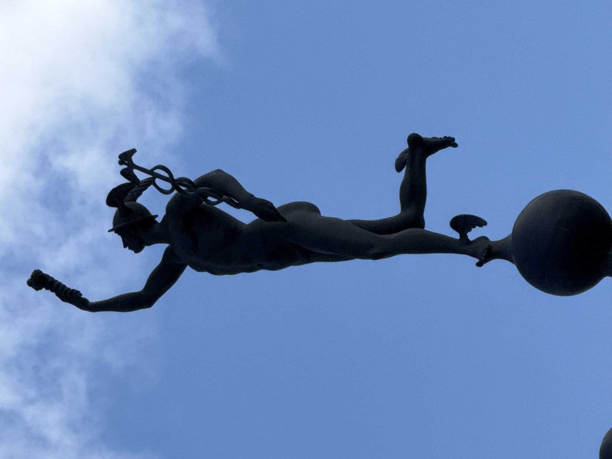Statues in the sky and a patterned bag up close