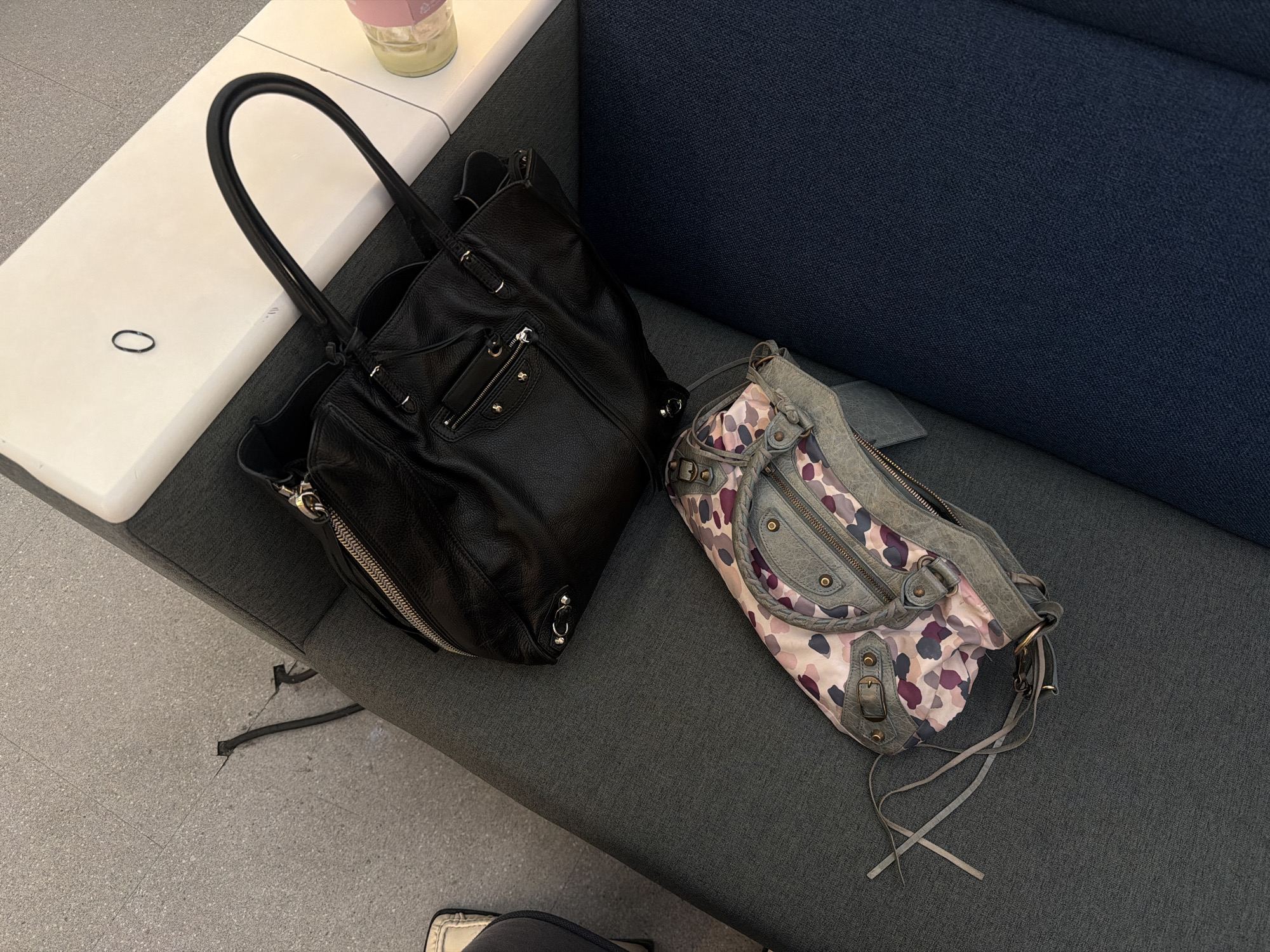 Two handbags documented on furniture in Seoul