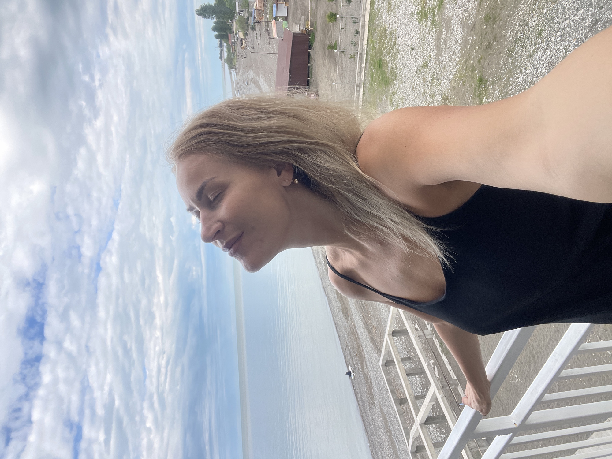 Woman enjoys early morning Black Sea views from Abkhazia balcony
