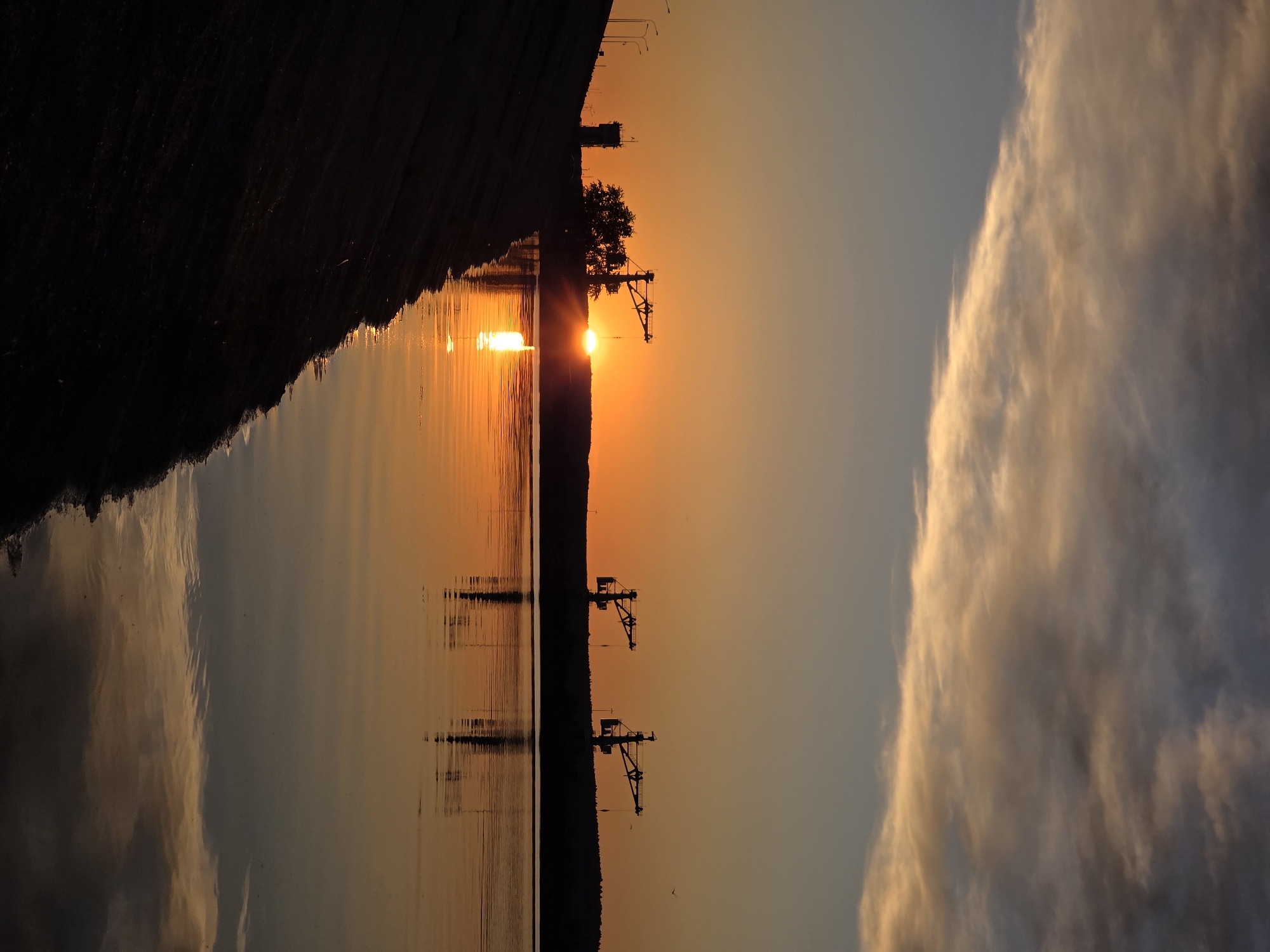 Woman documents sunset evening along Kama River in Chaikovsky