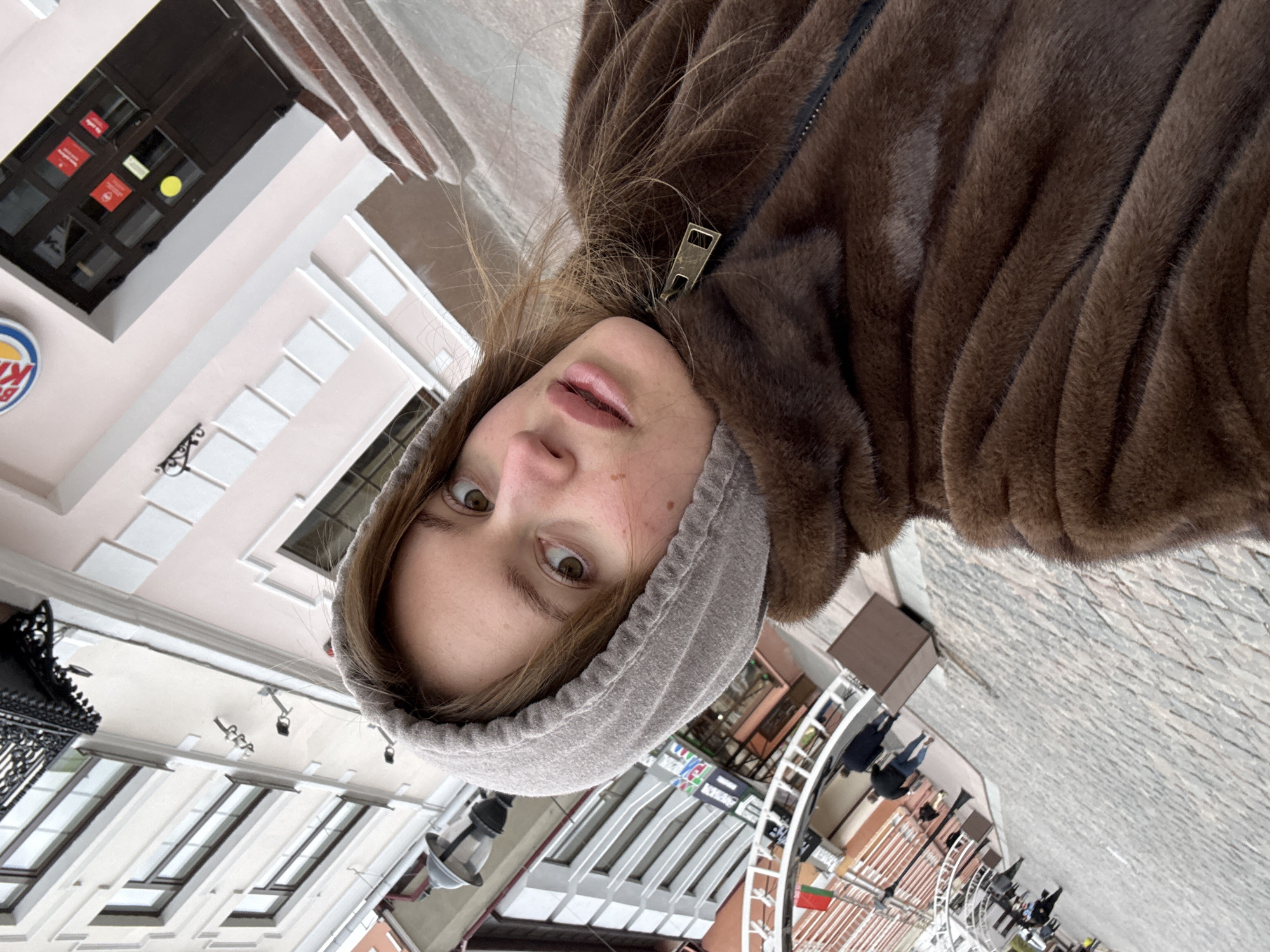 Woman takes selfie on historic pedestrian street in Hrodna