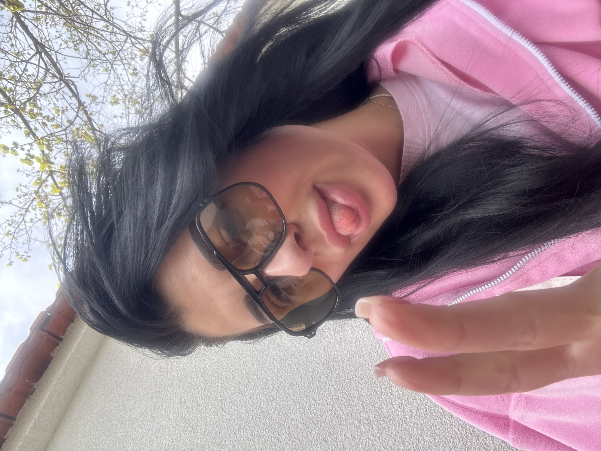 Woman takes playful selfie in pink jacket in Bulgaria
