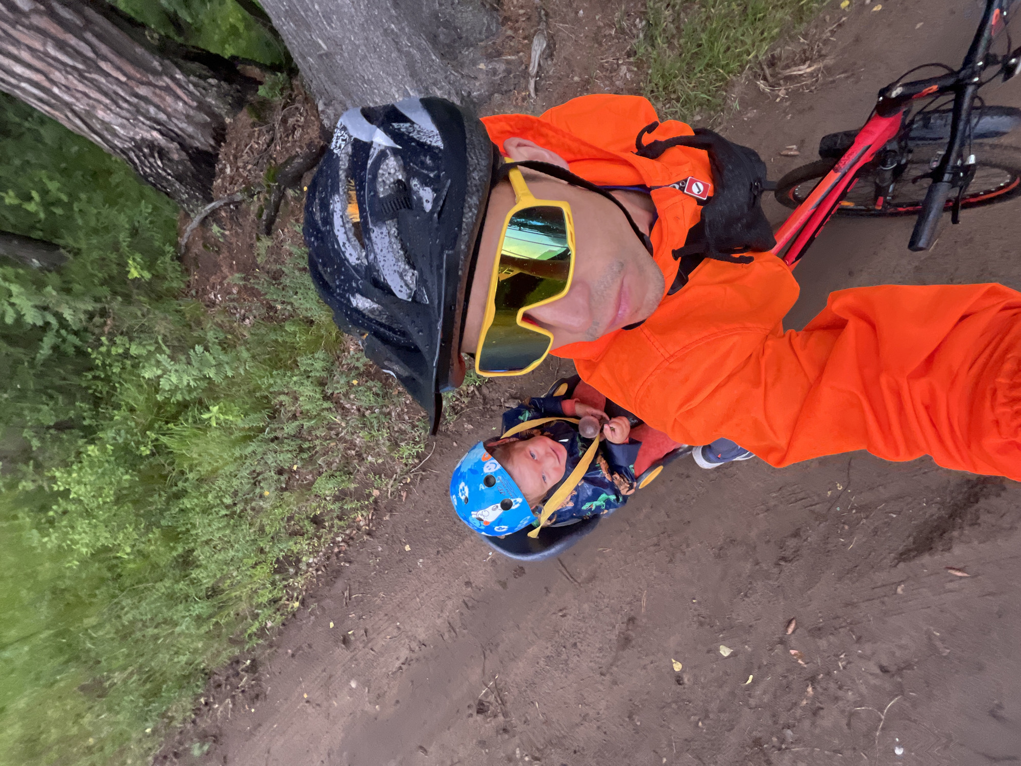 Mountain bike group rides muddy rural trails near Chaikovsky