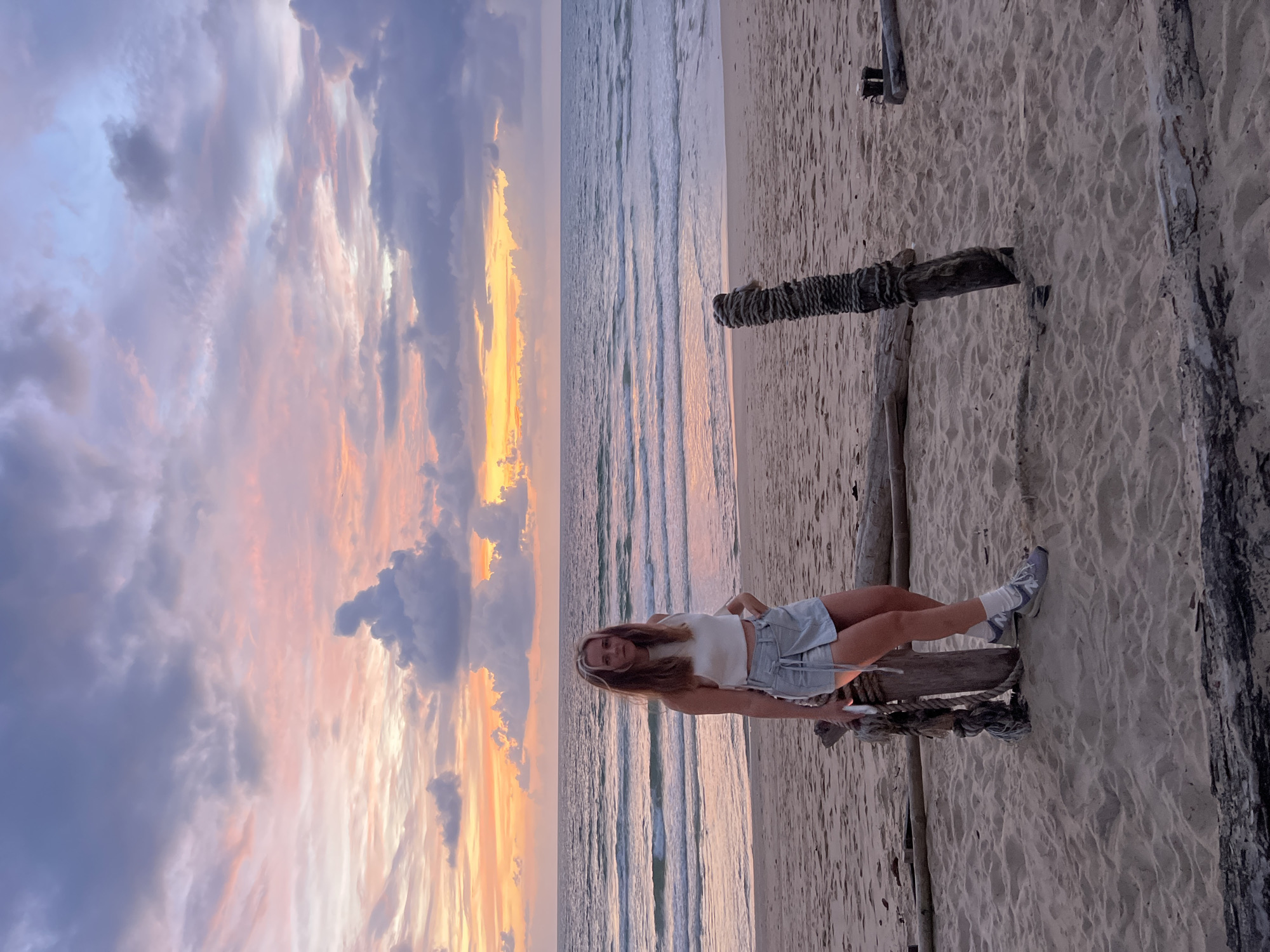 Stormy sunset at Surin Beach with beachgoers and a child