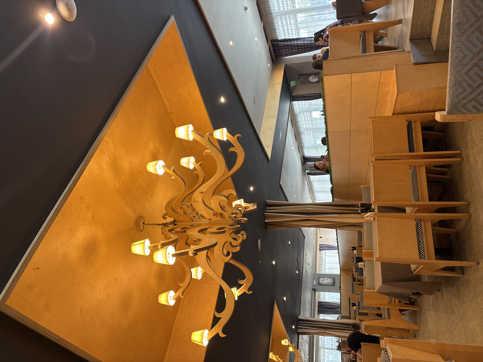 Restaurant interior with ornate wooden chandelier documented by witness