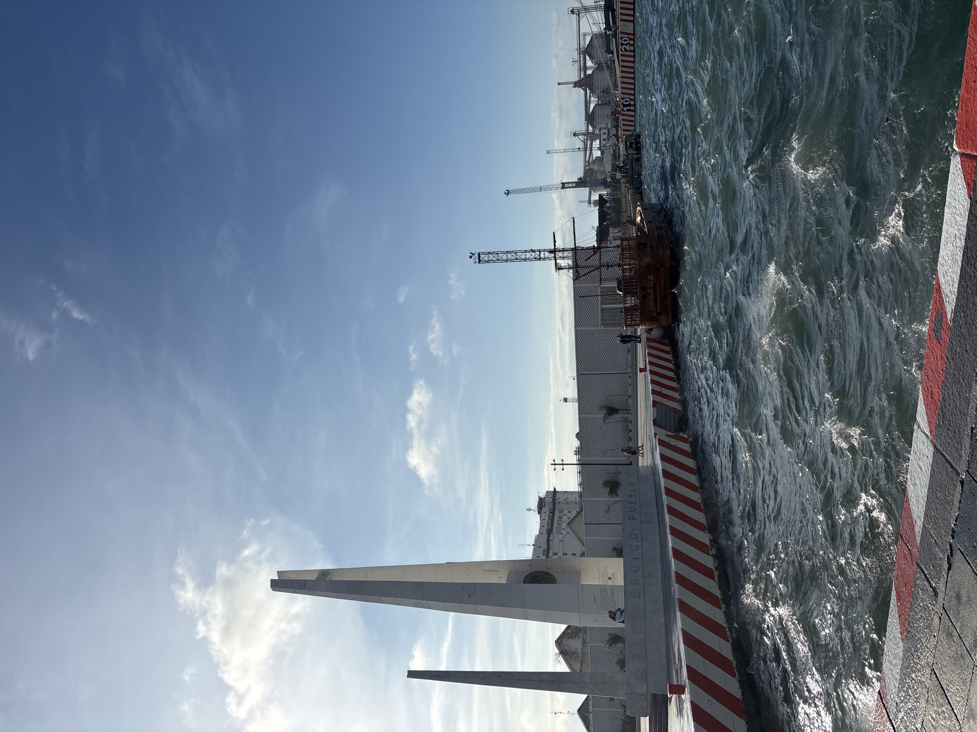 Choppy waters and rocky shoreline observed under cloudy sky