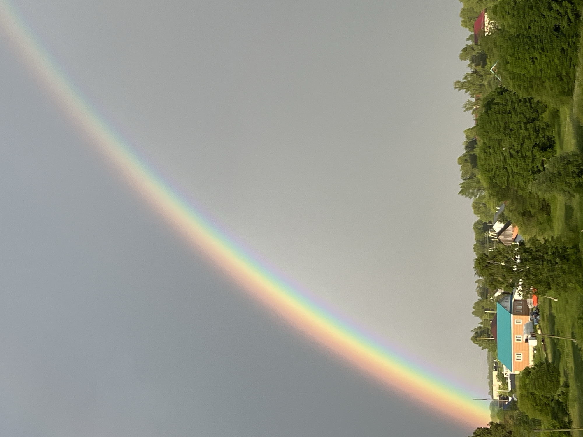 Double rainbow over a Russian village after a summer storm