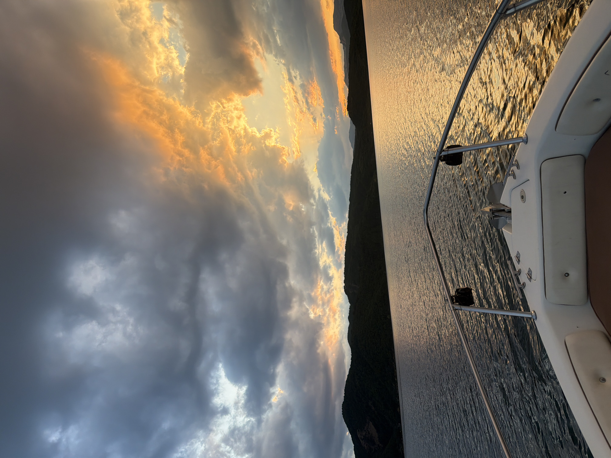Boat on Koprinka Reservoir under a dramatic summer sunset