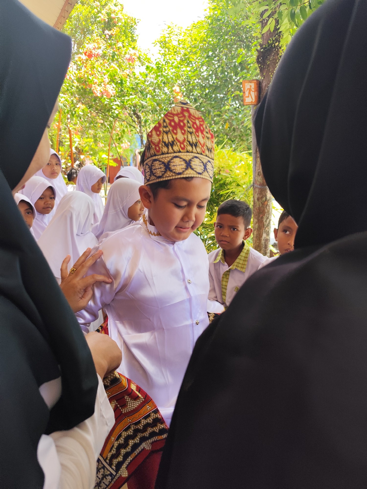 Children in traditional dress at a cultural school gathering