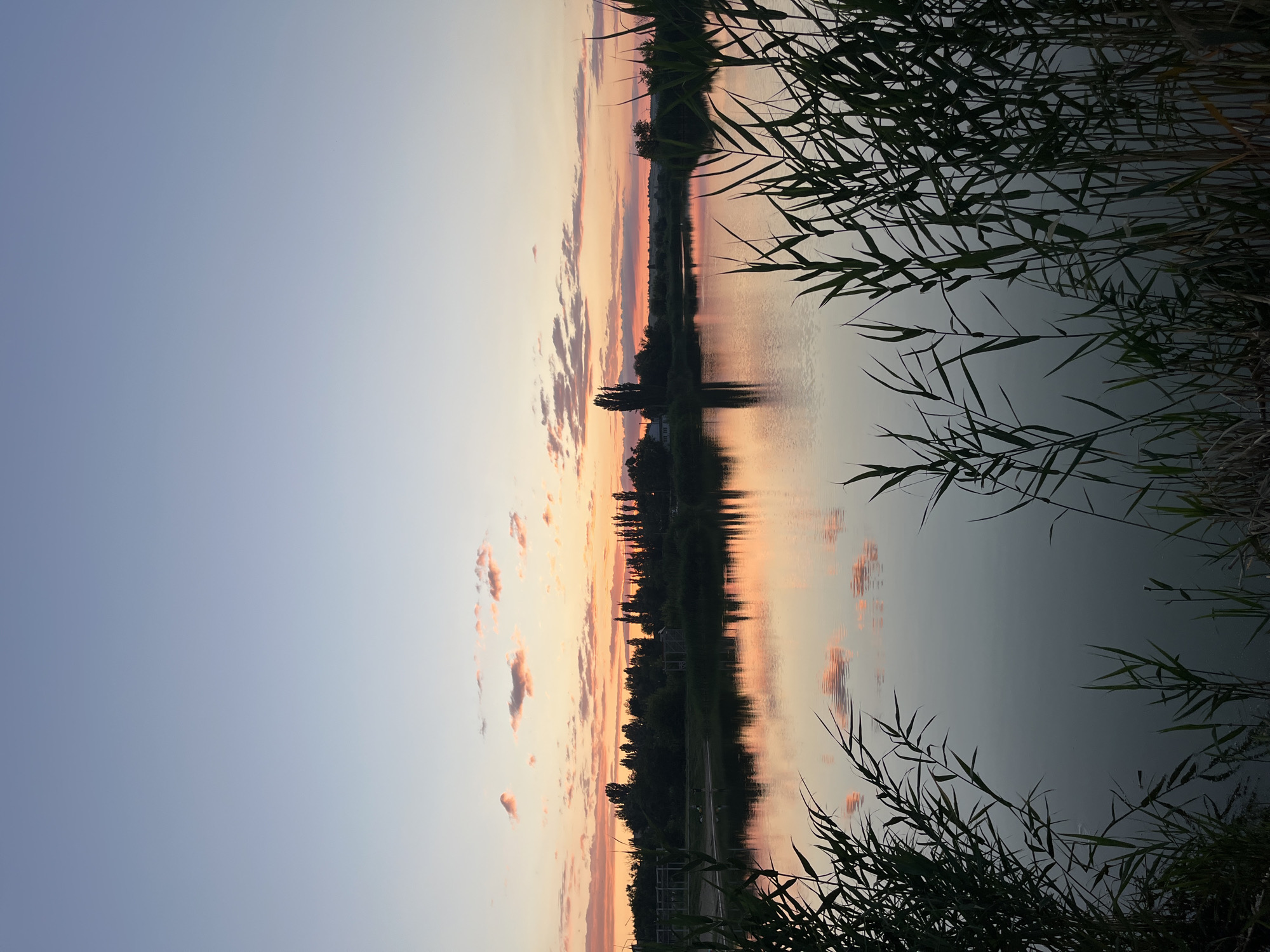 Sunset over calm water near Kotovo, Russia